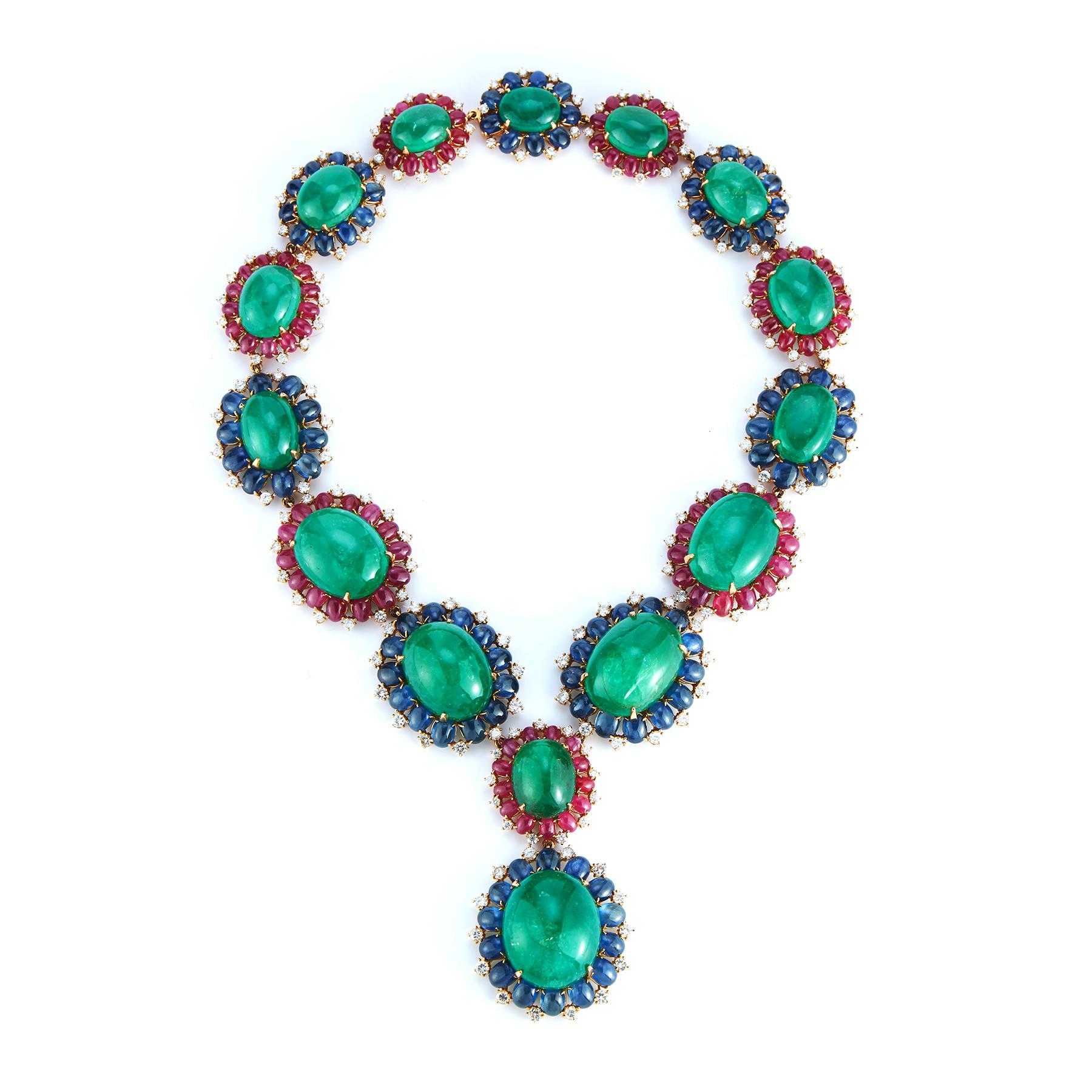 Bulgari Emerald Necklace and Earrings Set
The stunning necklace includes cabochon emeralds framed by cabochon sapphires and rubies, highlighted by round diamonds; the earclips similarly set.
Necklace length: 17¼ inches. 
Earring Length:  1 inch