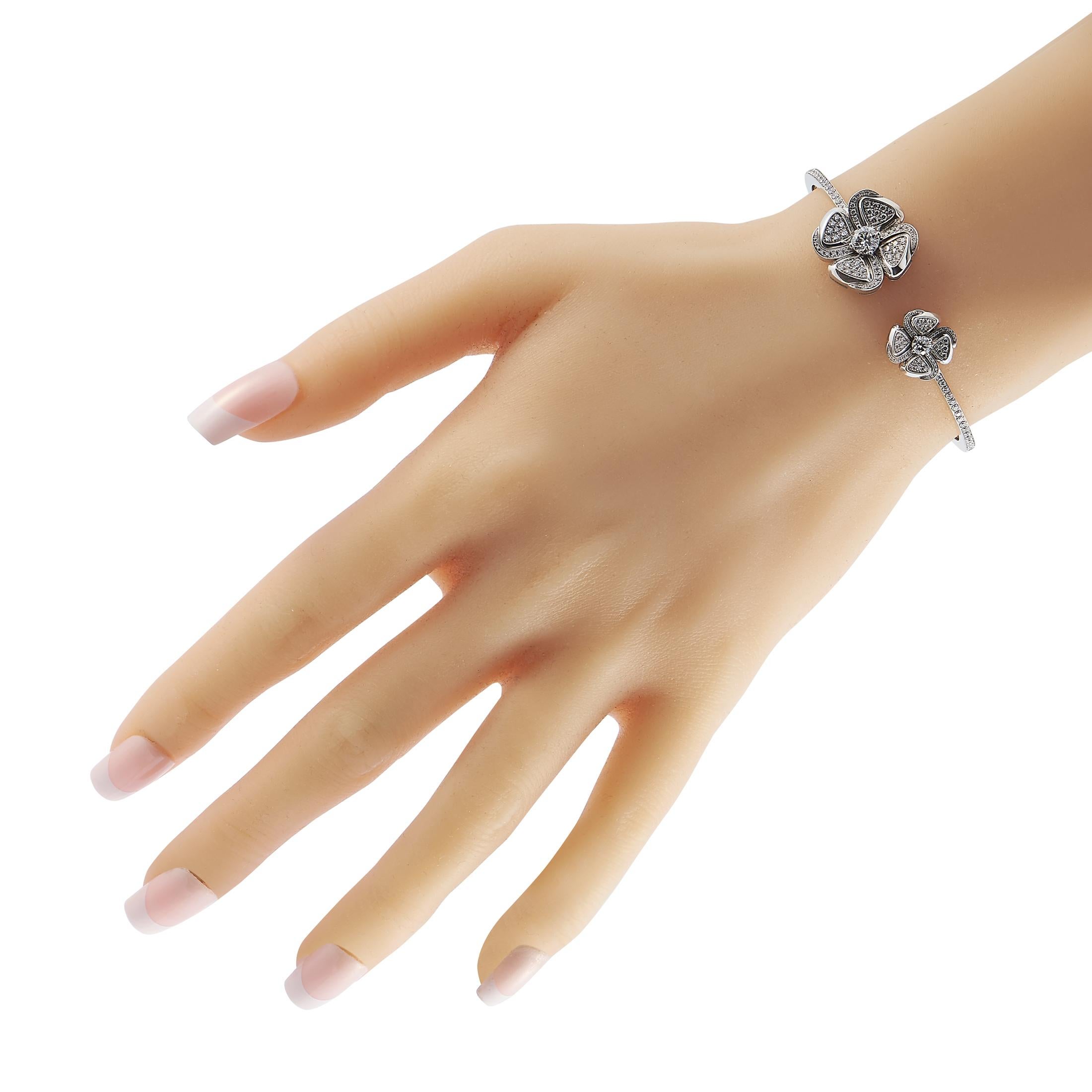 Made to deliver enduring brilliance, here is Bvlgari's Fiorever Bracelet. The piece is fashioned in white gold and has an open-circle silhouette. The two ends of the rigid bracelet bear two central diamonds, exquisitely detailed with rows and