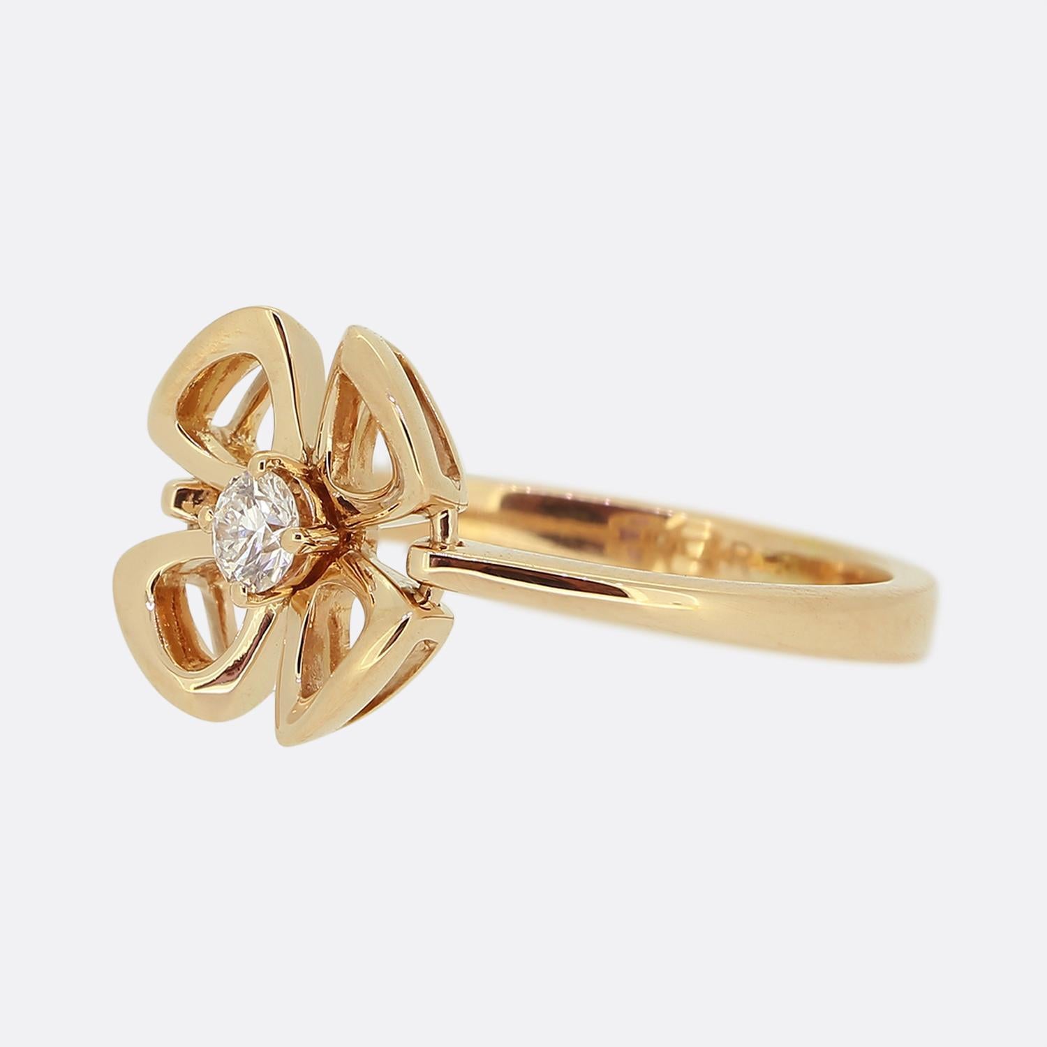 Here we have a wonderful diamond ring from the world renowned luxury jewellery house of Bvlgari. This piece forms part of their 'Fiorever' collection and showcases a single round brilliant cut diamond sitting in the centre of a floral design.