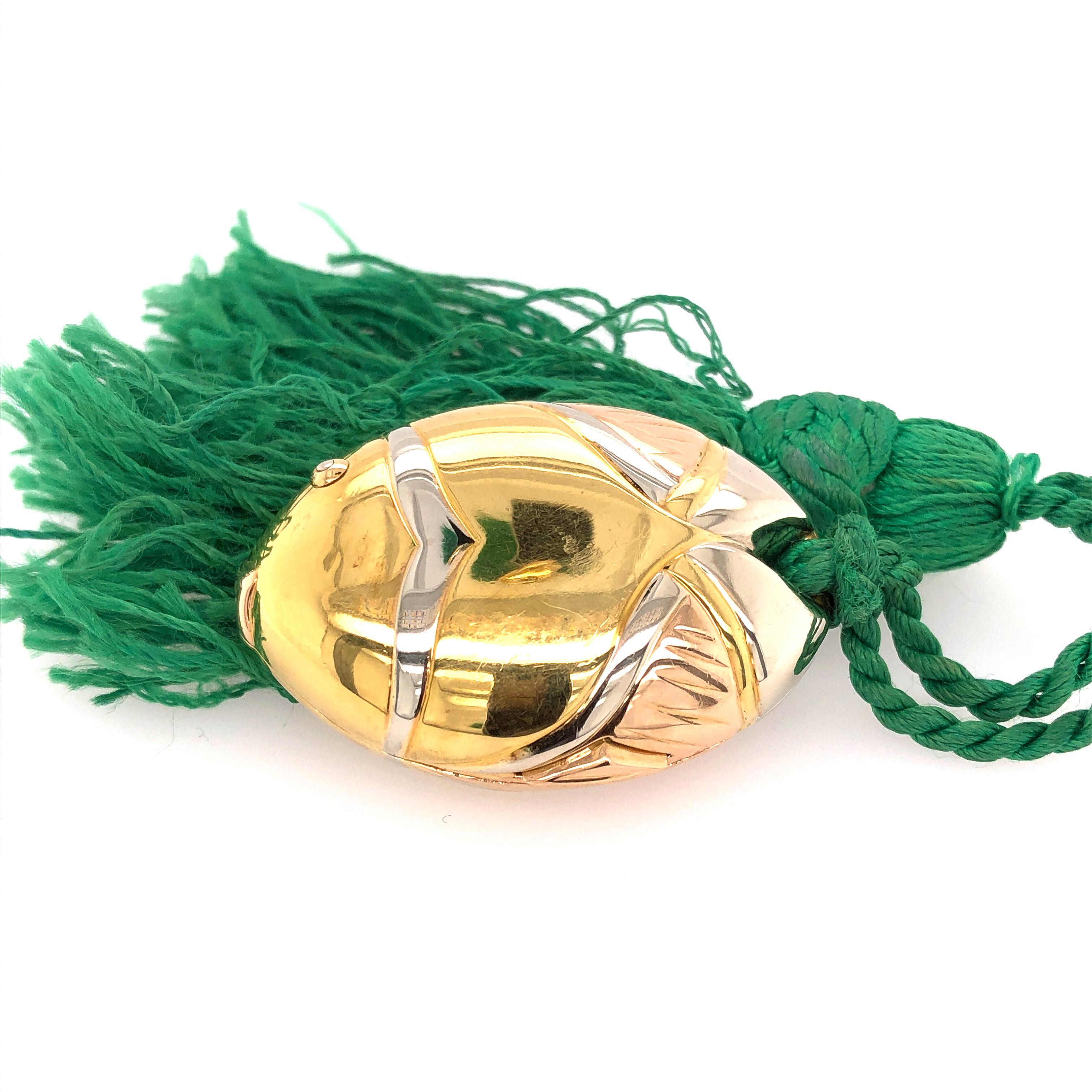 a unique piece this BULGARI fish Pillbox that can be worn as a pendant is a sure conversation starter. 18K yellow gold with a green tassel that serves as the tail. 

From the Skibell Estate Collection

Stamped: 750 BVLGARI 2337AL
