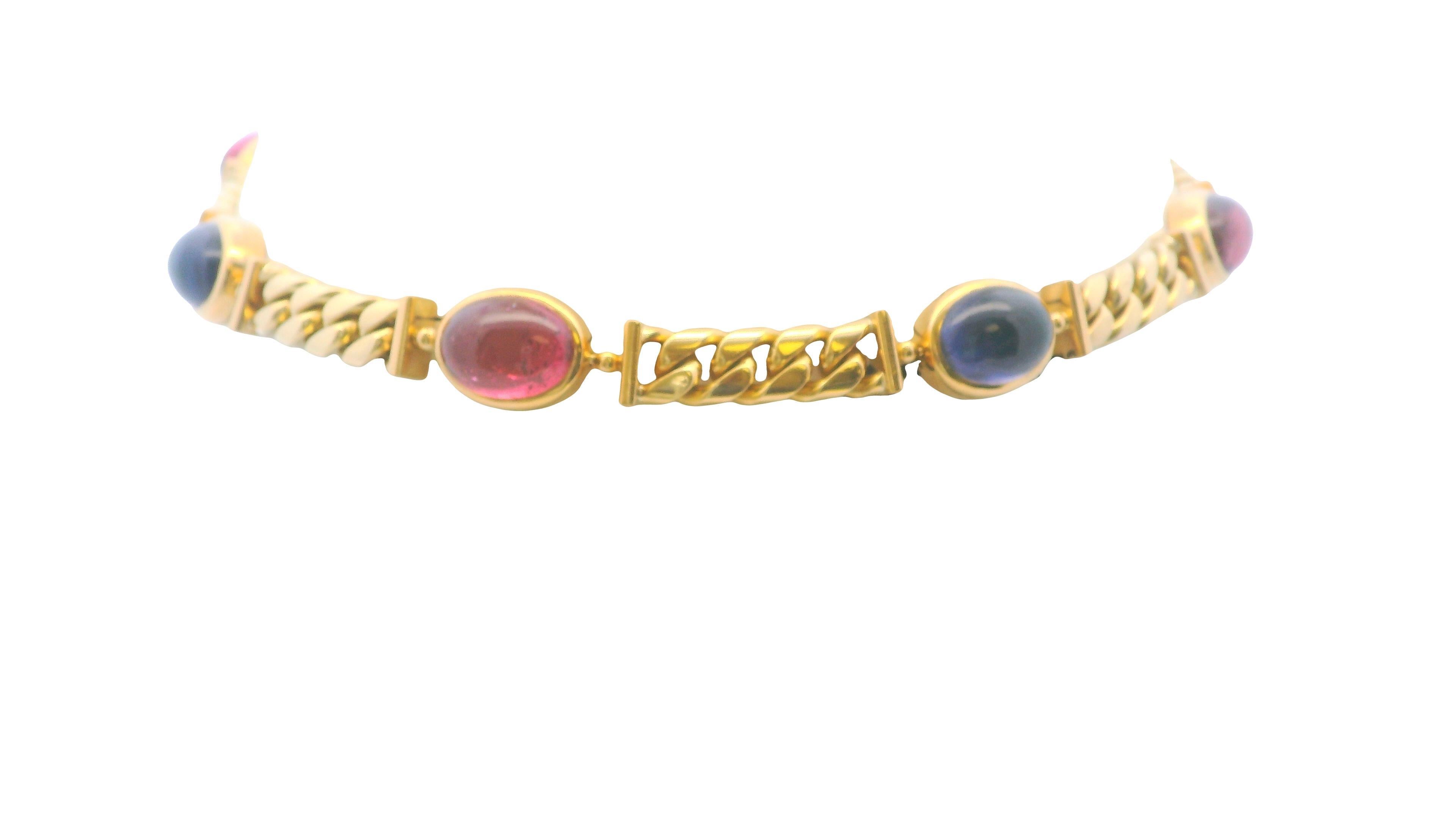 Enhance your jewelry collection with the exquisite Bvlgari Five Station Necklace, crafted from luxurious 18K yellow gold. This elegant piece features a bold curb link chain adorned with five bezel-set cabochon gemstones, showcasing Bvlgari’s