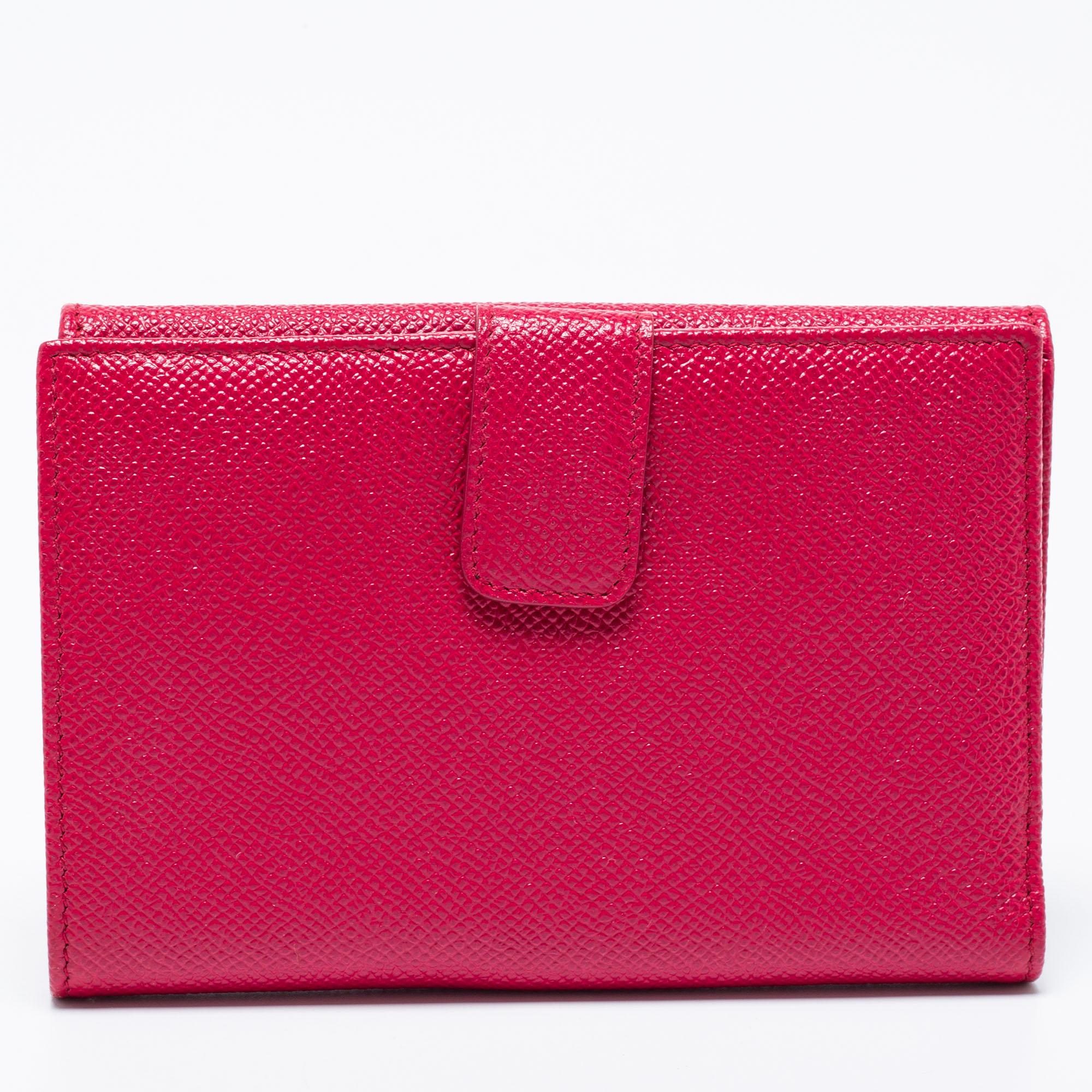 This Bvlgari wallet arrives in a gorgeous shape and trifold design. It has a bright fuchsia leather body with beautiful gold-tone details. The front flap secures the well-sized interior that comes equipped with multiple card slots.

Includes: