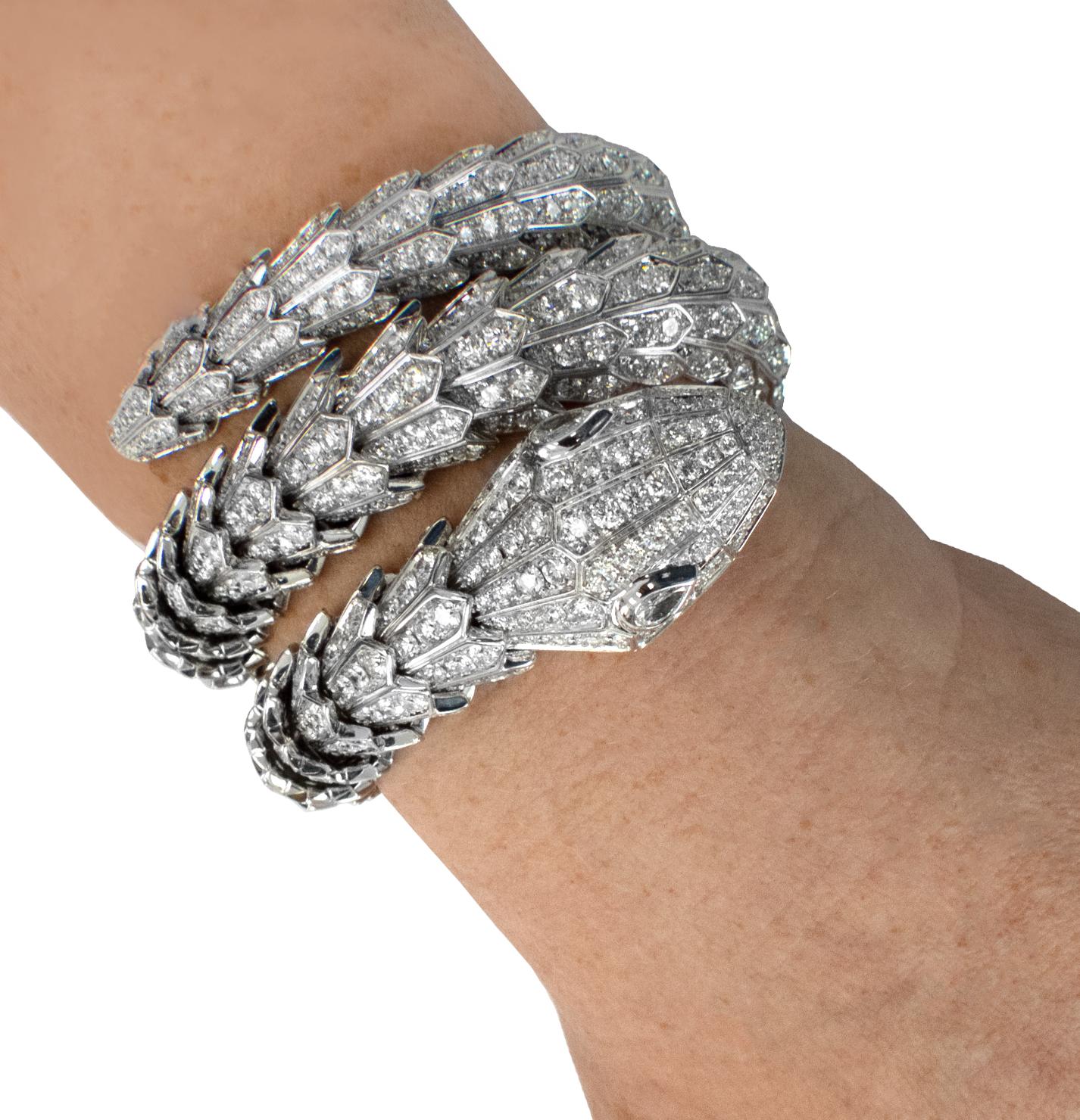From the esteemed ateliers of Bvlgari Italy emerges a masterpiece that epitomizes grandeur and sophistication – the Bvlgari Serpenti Diamond Triple Wrap Bangle Bracelet. Meticulously crafted in the ethereal luminance of 18-karat white gold, this
