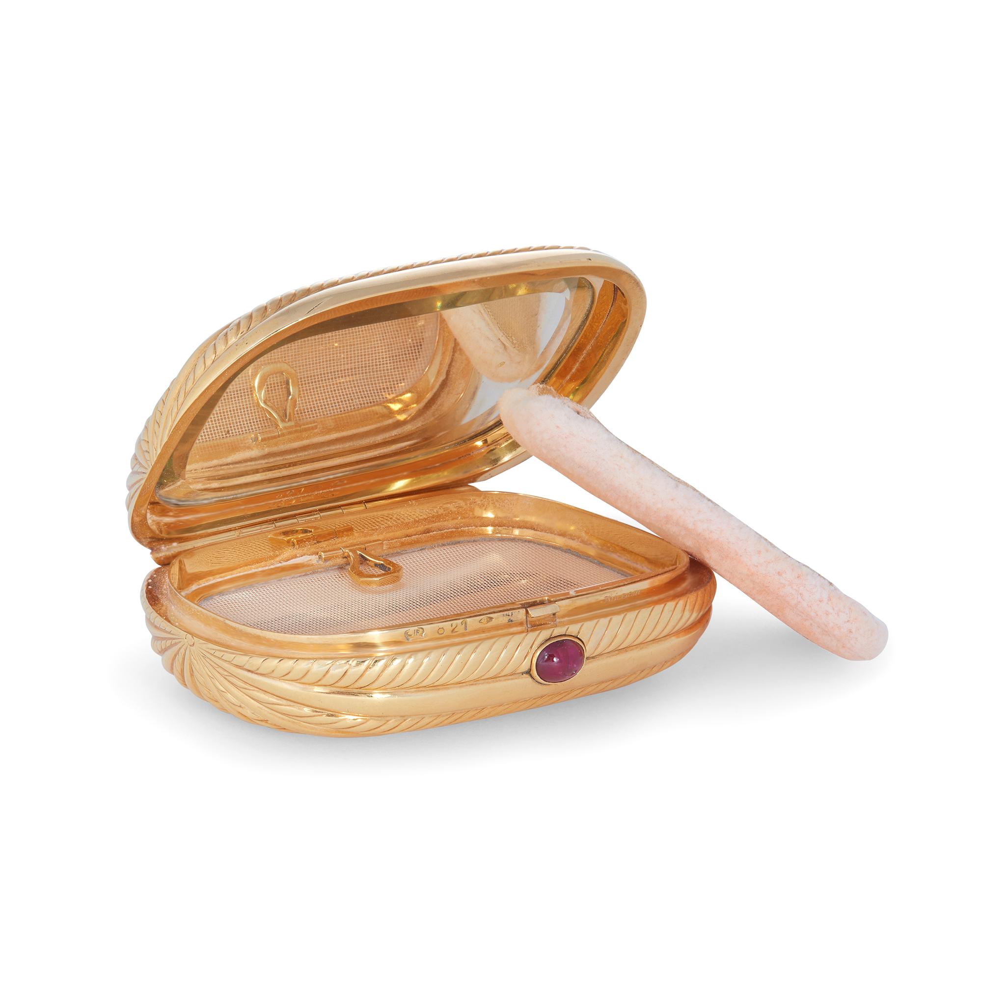 Authentic Bvlgari compact case crafted in 18 karat yellow gold. The cushion-shaped clamshell case features an elegant design of fluted gold rows with a cabochon ruby clasp.  The case measures 3.14 inches x 2.41 inches and features an interior mirror