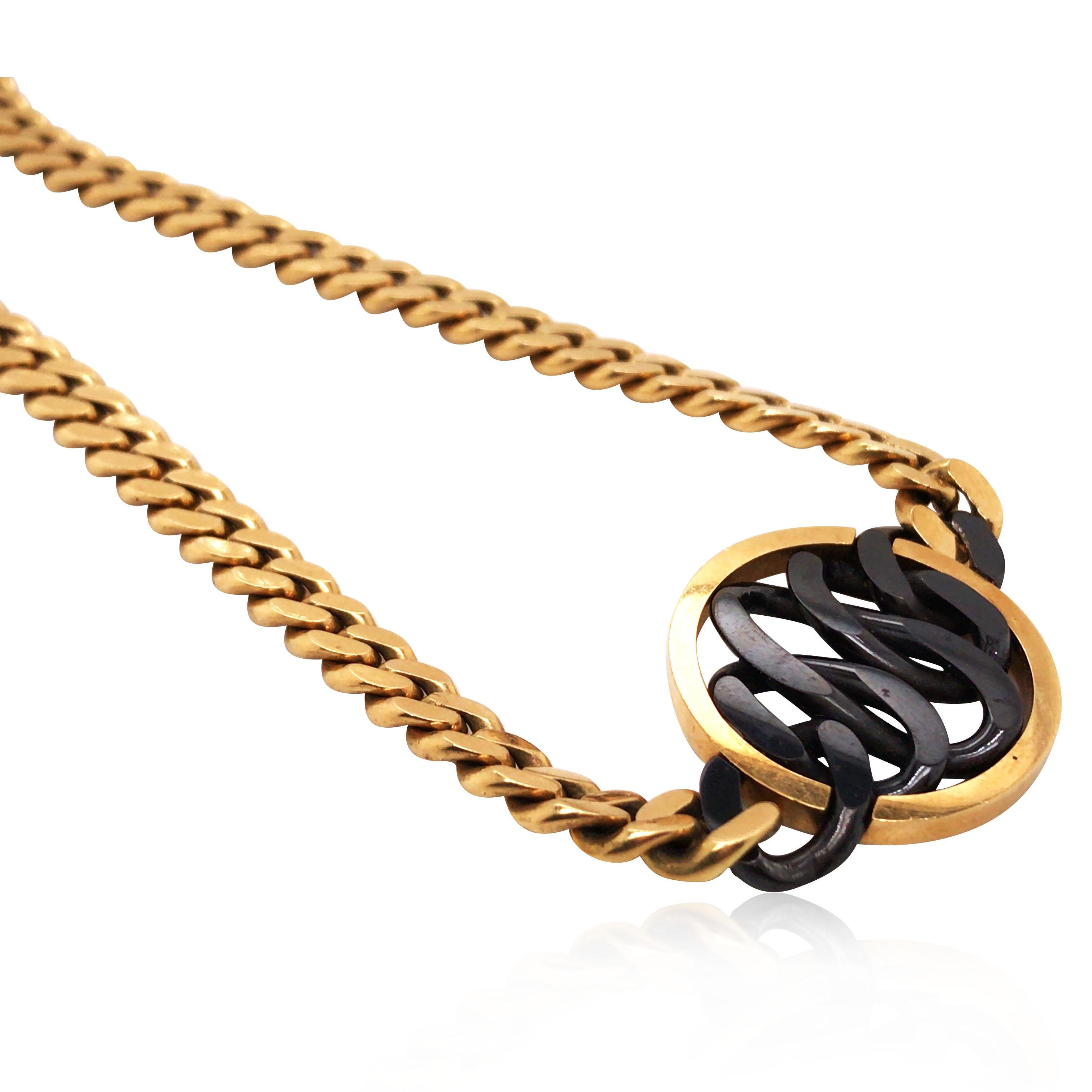 This Bvlgari Onyx necklace has the structure of intertwining circles. The Onyx circles are contained in a round gold circle in the center.

Weight: 55.8 grams
Measurement: 38 cm in length
Stamp: 