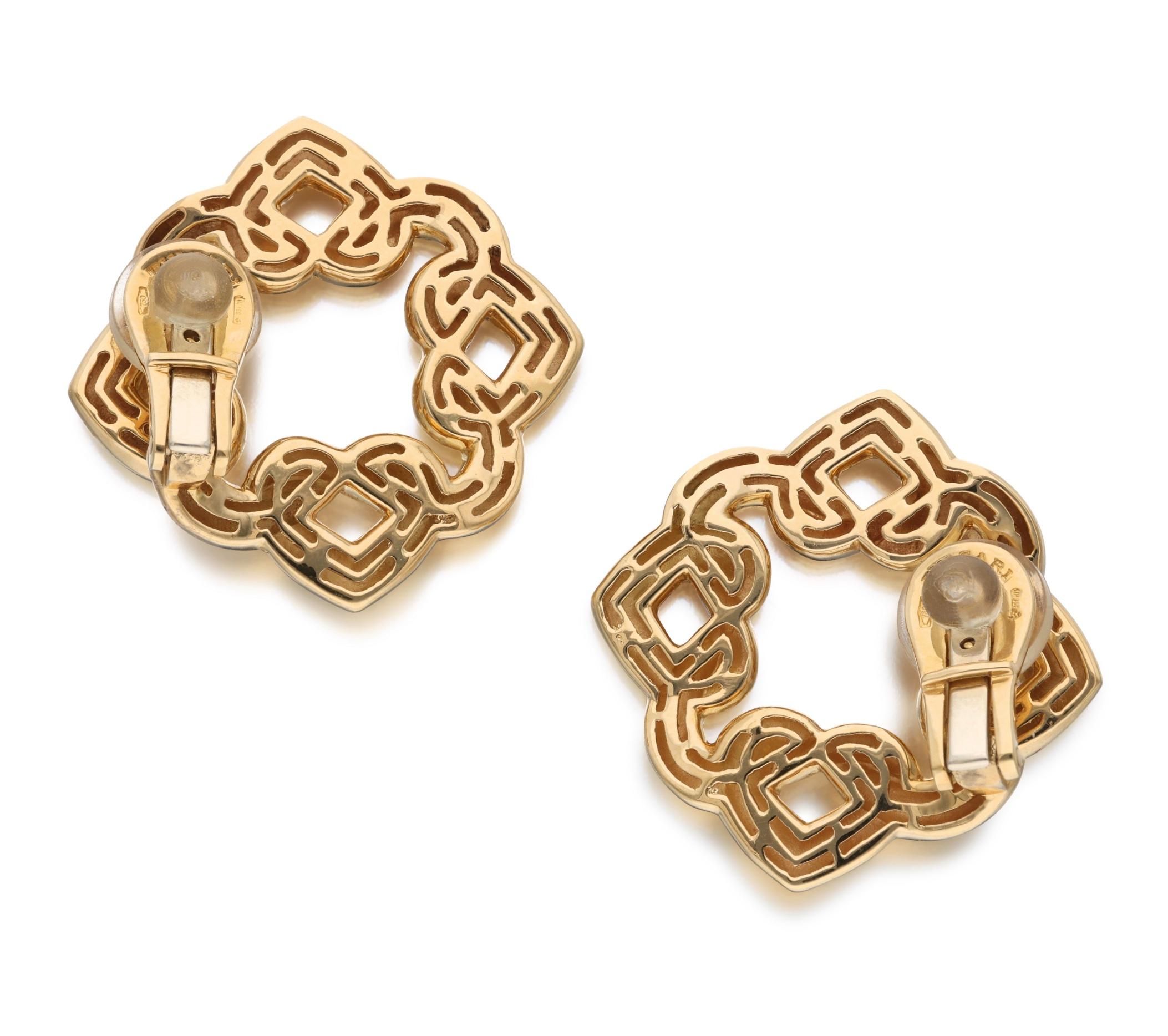 These creative ear clips are designed as interlocking gold hearts.

- Signed Bvlgari
- Italy
- 18 karat yellow gold
- Total weight 18.23 grams
- Length 1¼ inches, width 1¼ inches

The condition report is Very Good. 

Perfect for casual settings. 