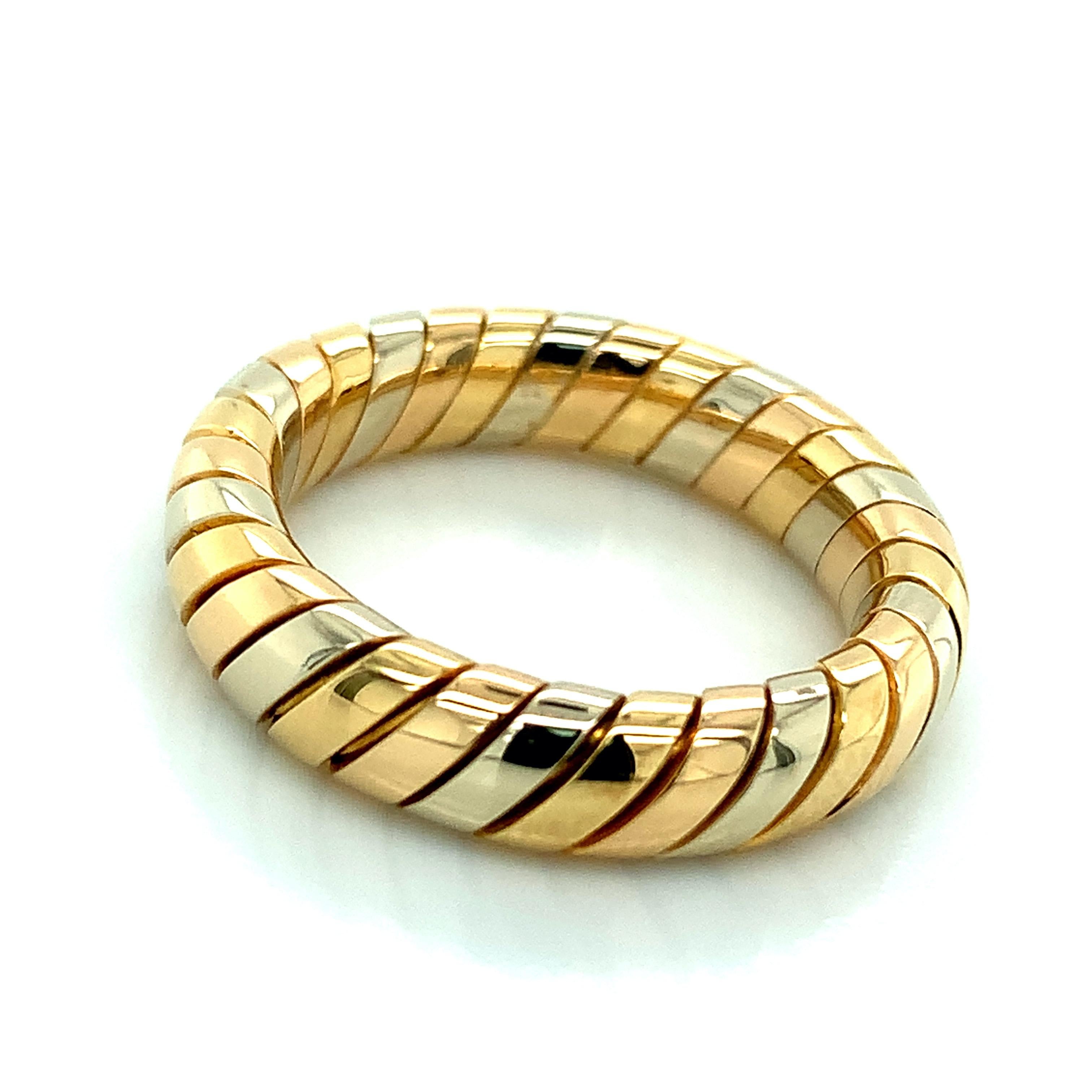 Bvlgari 18 karat yellow, white, and rose gold ring from the iconic Tubogas collection. Marked: Bvlgari / Made in Italy. It weighs 7.2 grams. Size 5.75-6.