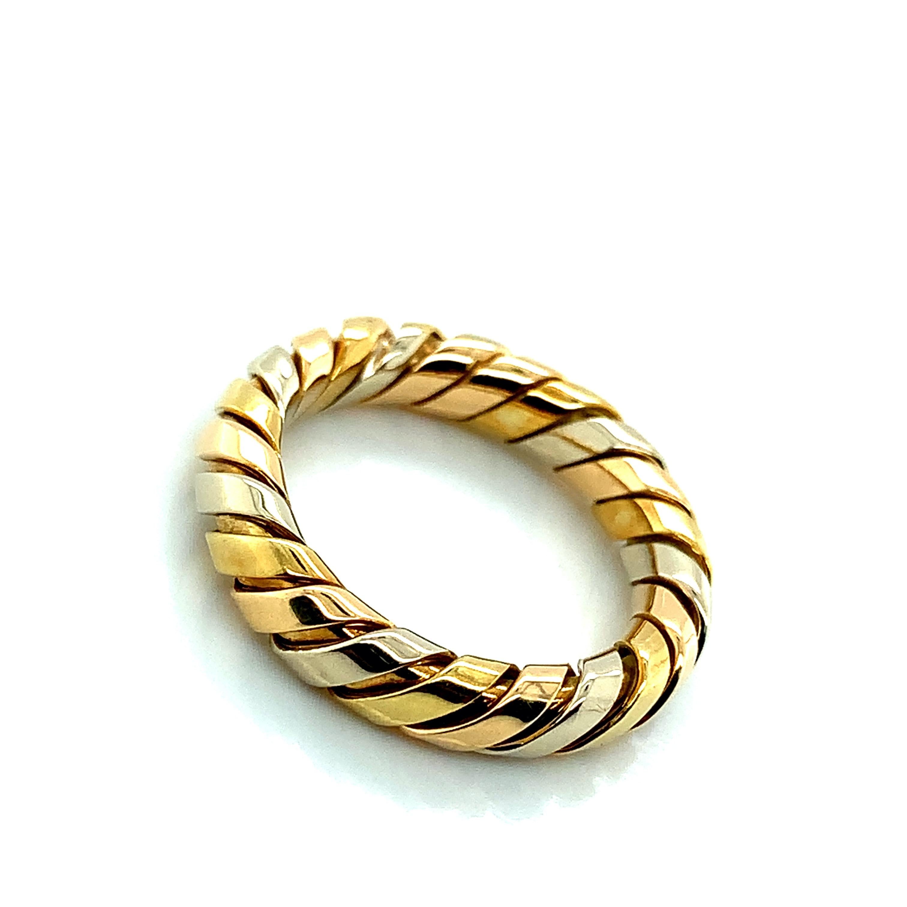 Bvlgari 18 karat yellow, white, and rose gold ring from the iconic Tubogas collection. Marked: Bvlgari / Made in Italy. It weighs 4.9 grams. Size 6-6.25.