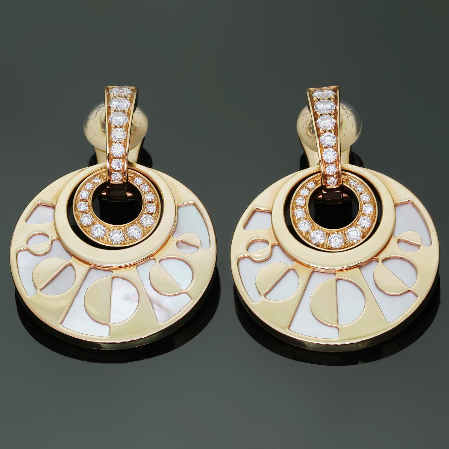 These stunning Bvlgari pendant earrings from the elegant Intarsio collection feature a round geometric cutout design crafted in 18k rose gold and mother-of-pearl and accented with brilliant-cut round E-F VVS1-VVS2 diamonds weighing an estimated 0.95