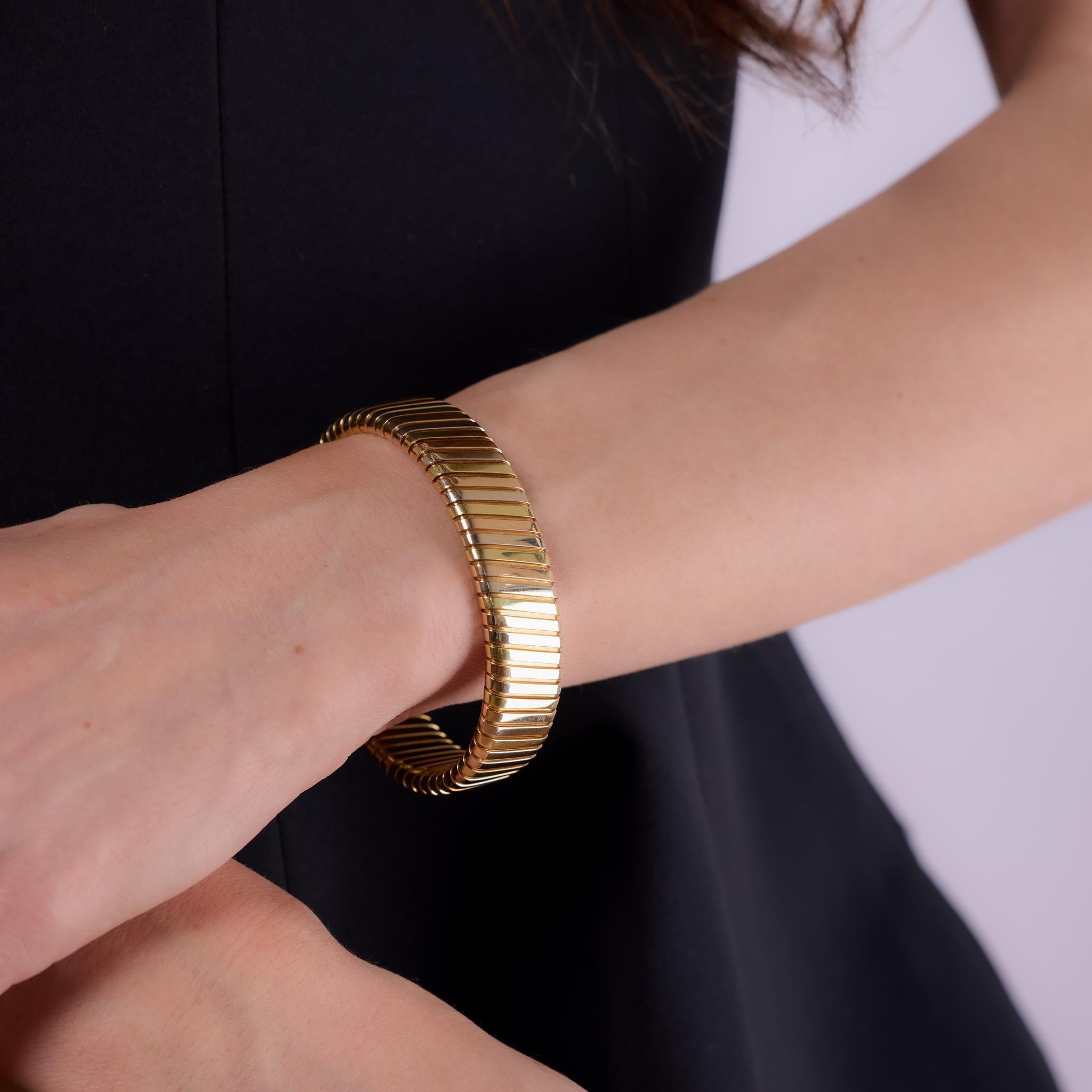Crafted in the 1970s, this vintage Bvlgari Tubogas bracelet is a striking example of Italian craftsmanship and design innovation. Made in 18k yellow, white, and rose gold, the coiled form flexes comfortably around the wrist with the signature