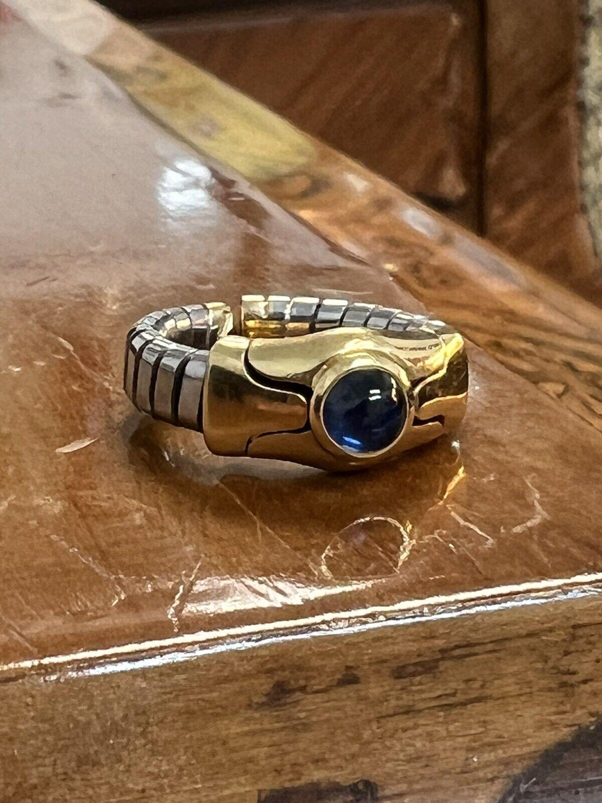 Bvlgari Italy 18k Yellow Gold, Cabochon Sapphire & Stainless Steel Tubogas Ring Vintage

Here is your chance to purchase a beautiful and highly collectible designer ring.  Truly a great piece at a great price! 

Weight: 7.7 grams

Condition: Great
