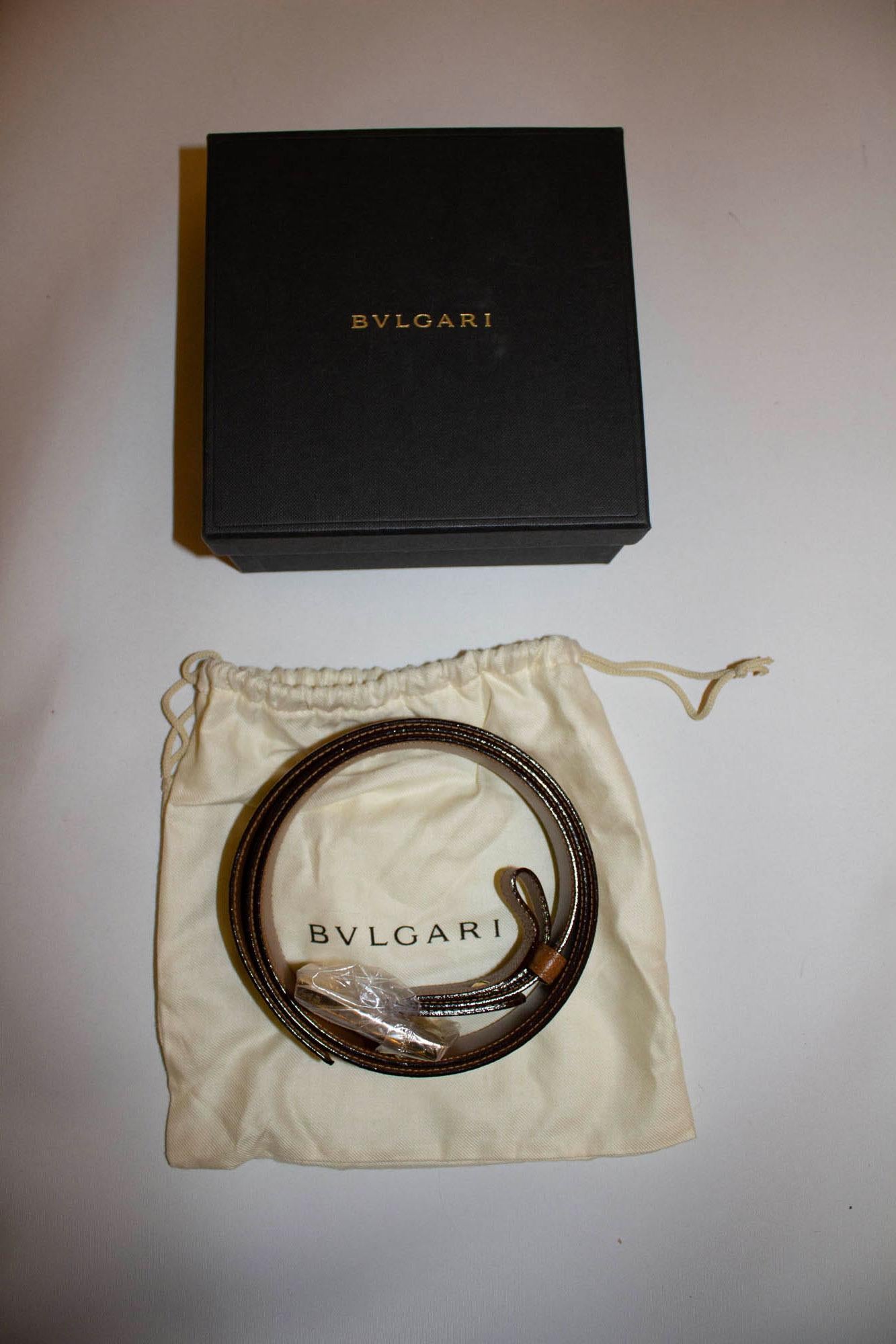 A wonderful leather belt by Bvlgari , unused with original box, and dust bag. The belt is in a textured leather with heavy gold buckle. Leather belt, length 45'', height 1 1/2''