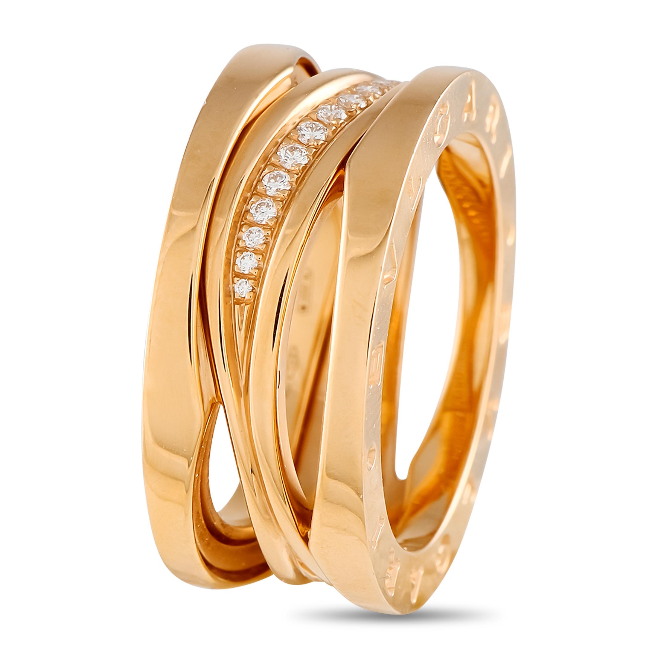 This Bvlgari Legend ring is simply unforgettable. Crafted from 18K Rose Gold, elegant open metalwork elevates the dynamic design. It comes complete with features the brands signature at each end as well as a row of sparkling Diamonds at the center.