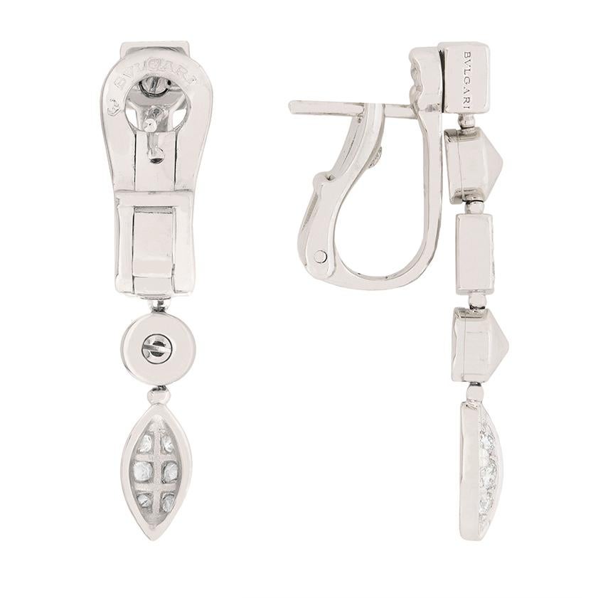 These sparkling earrings are a rare piece from the Lucea range. The alternating square and circle design has strong art deco influences and each earring is finished with a metal marquise shaped with grain set diamonds. The squares are also grain set