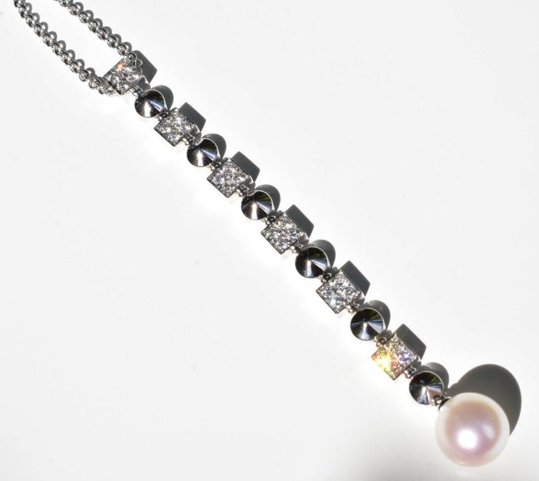 A Bvlgari Lucea diamond and pearl drop necklace set in 18k white gold. The necklace features six square shape forms, each set with four brilliant round-cut diamonds, between each square is a round polished round dot with a dangling natural pearl of
