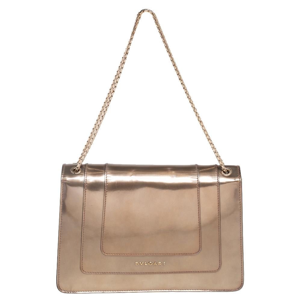 Add a dazzling element to your style with this stunning Bvlgari creation. Crafted from metallic bronze patent leather, the shoulder bag has a flap that has the iconic Serpenti head closure. The bag has a lined interior and a gorgeous gold-tone chain