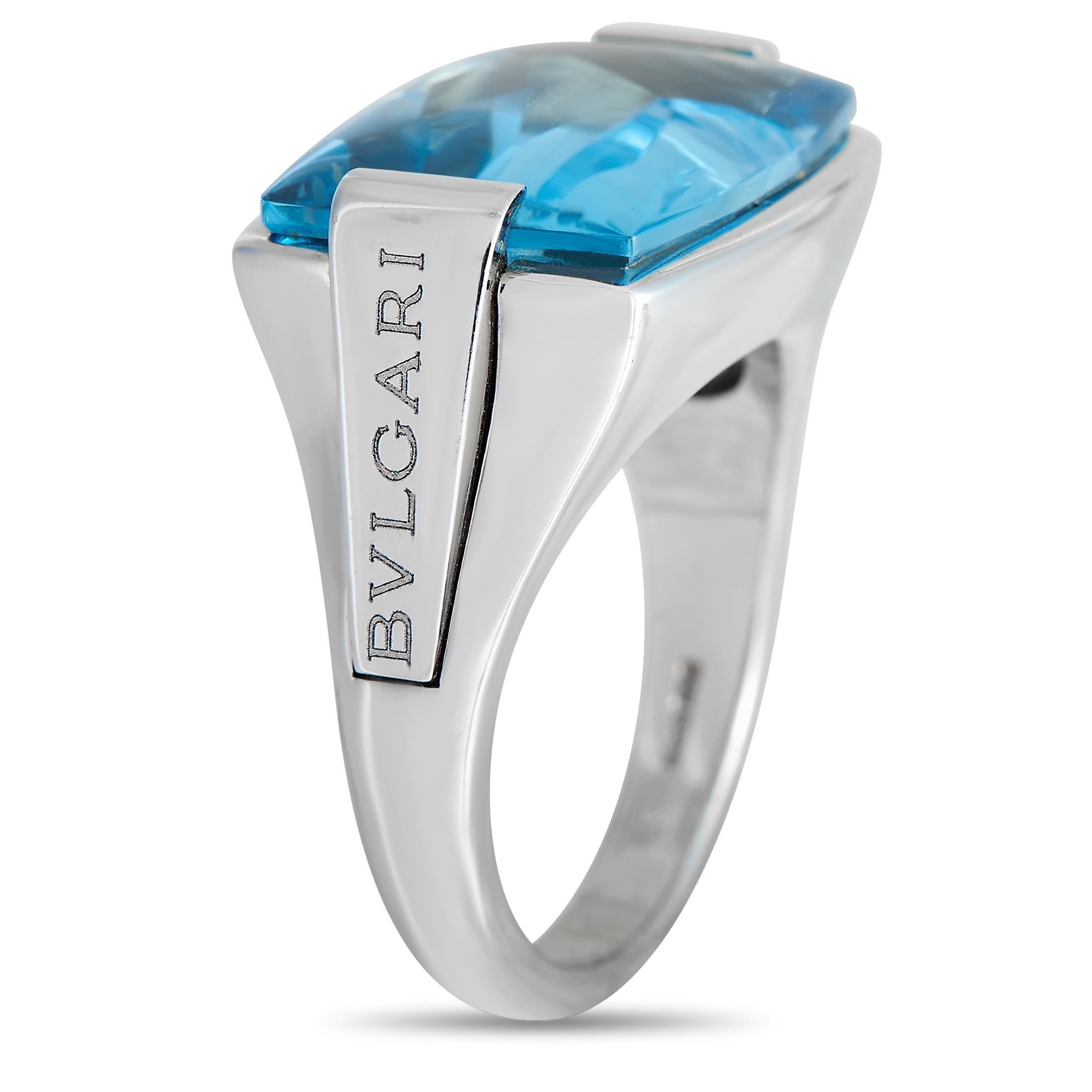 Big, bold, and beautiful, this Bvlgari cocktail ring is a statement piece you can wear with many different looks. It features an 18K white gold band with a large buff top topaz cabochon set in between white gold shoulders engraved with the iconic
