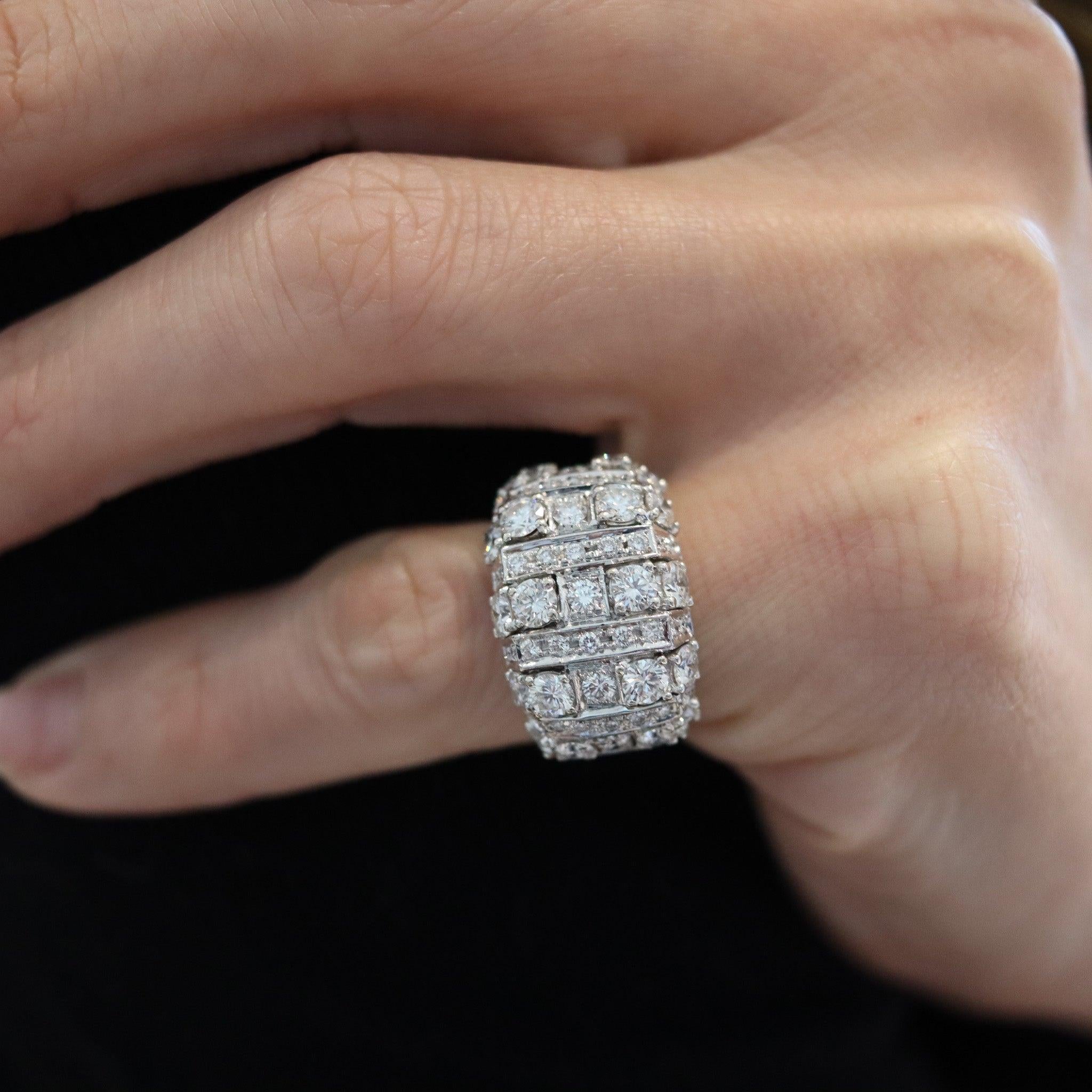 A diamonds cocktail ring designed by Bvlgari.

This is a beautiful cocktail ring-band created in Italy by the iconic jewelry house of Bvlgari, back in the 2000. The gorgeous ring has been crafted with modernist patterns in solid white gold of 18