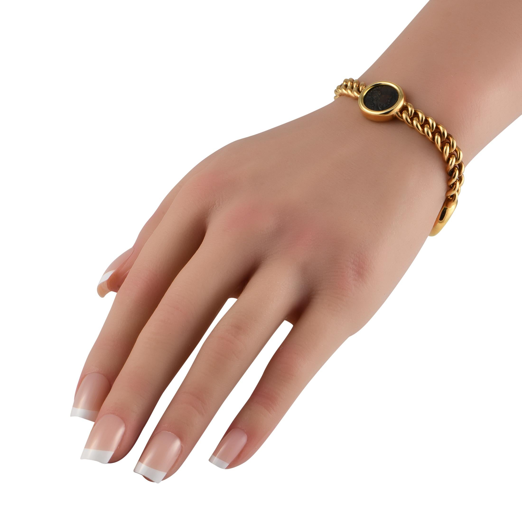 This Bvlgari Monete bracelet exudes old fashioned elegance. Crafted from opulent 18K Yellow Gold, this piece comes to life thanks to the trio of ancient Roman coins that have been elegantly incorporated into the design. It measures 7 long and comes