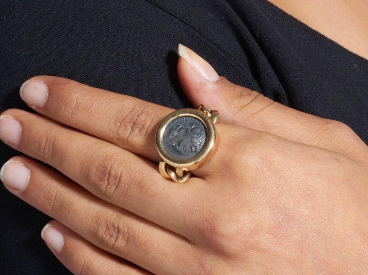 From the highly sought-after Bvlgari Monete collection, a 18k yellow gold ring with flexible curb chain and a real ancient Roman silver coin (trajan denar) setted in bezel settings.

Conceived by Nicola Bulgari in 1966, the Monete collection