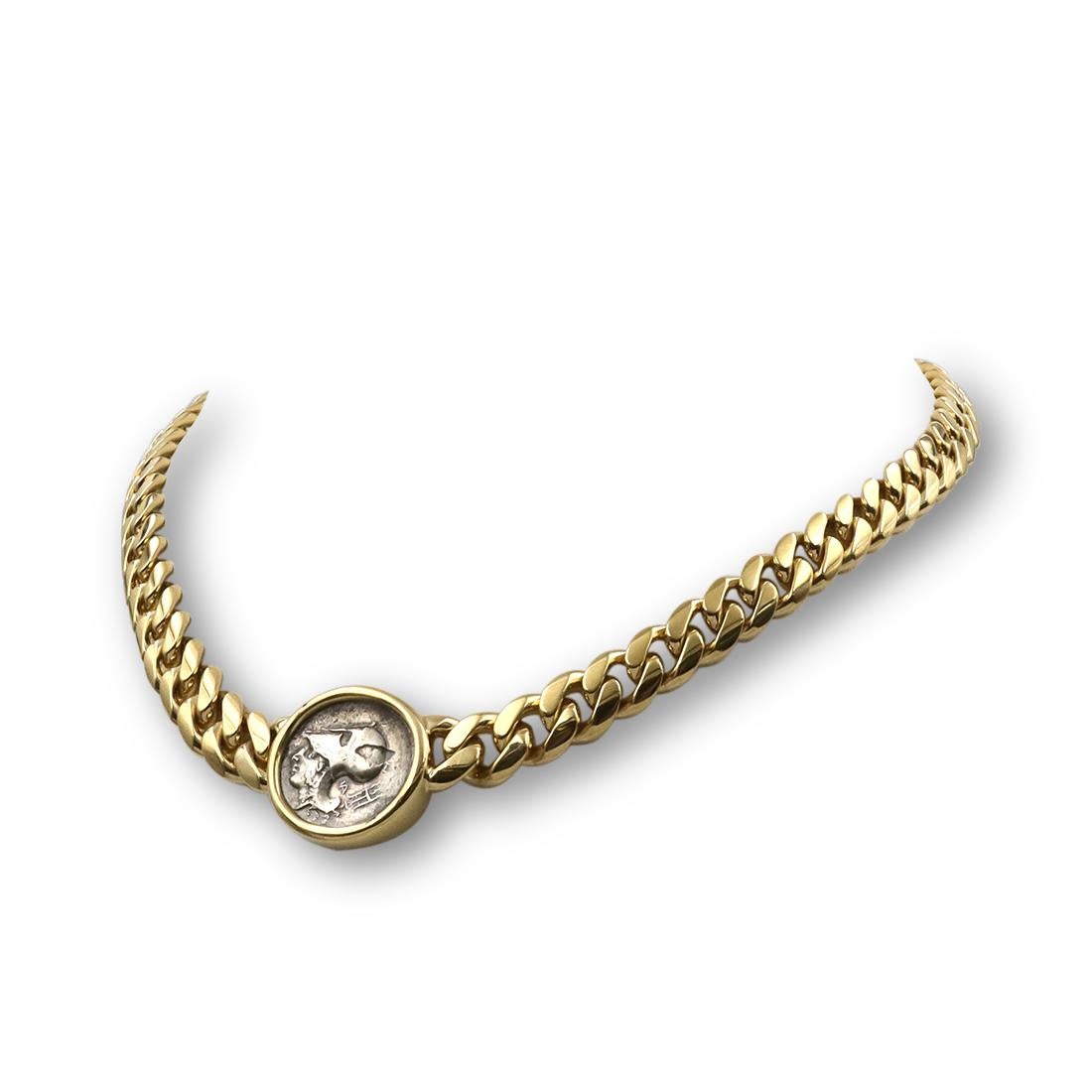 Authentic Bvlgari 'Monete' coin necklace crafted in 18 karat yellow gold. The graduated curb link necklace features an ancient 4th century coin depicting Corinth Anactorium that is set in yellow gold. The bezel setting is stamped on the back with