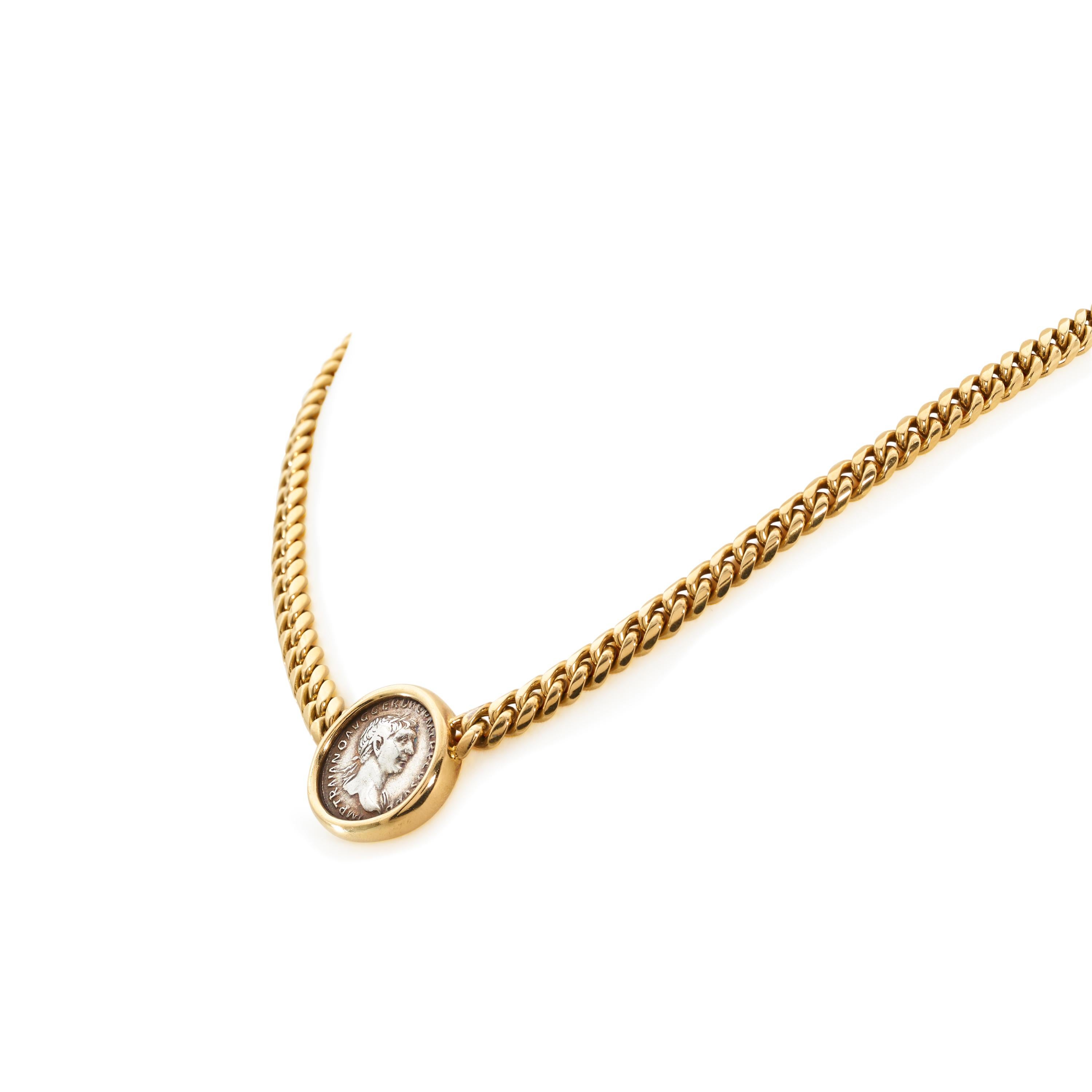 Authentic Bvlgari 'Monete' coin necklace crafted in 18 karat yellow gold. The curb link necklace features an ancient Roman coin depicting Caesar Nerva Traianus that is set in yellow gold. The bezel setting is stamped on the back with 'Roma- Traianvs