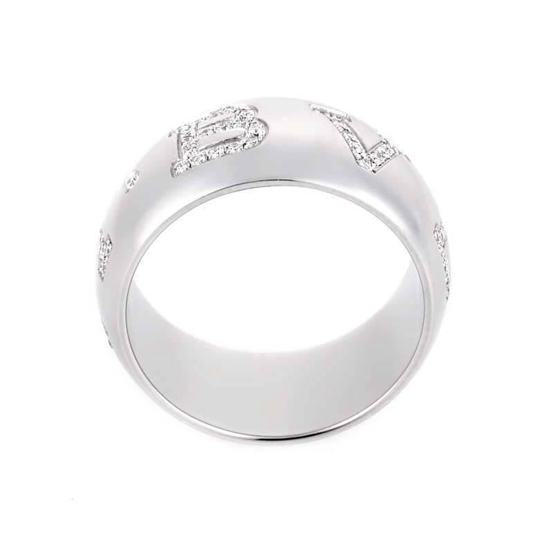 This Bvlgari Monologo band ring is sophisticated and elegant. It is made of 18K white gold and is inscribed with the BVLGARI logo. The logo is set with ~.9ct of diamonds.