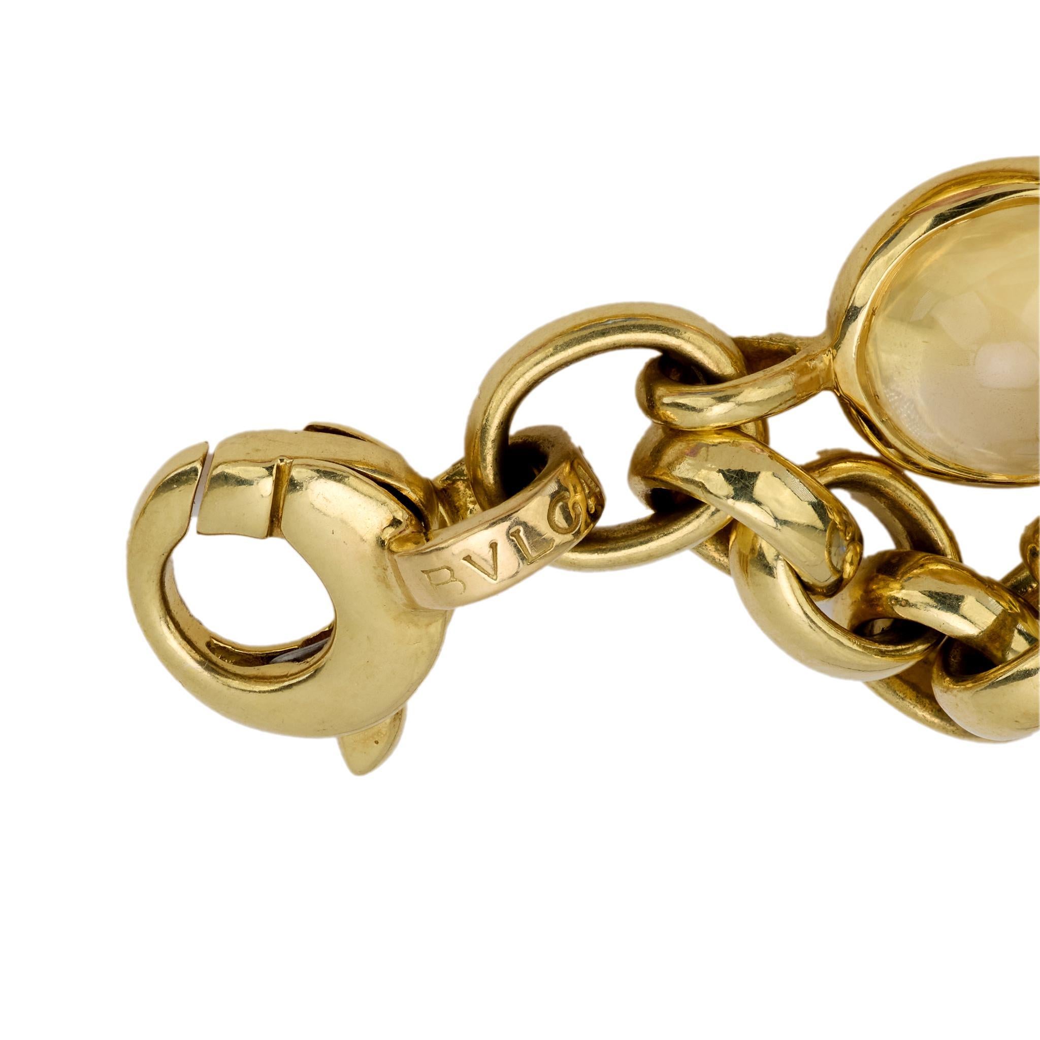 Crafted in the 1980s, this vintage Bvlgari chain bracelet showcases 9 luminous cabochon cut sapphires in a vibrant array of colors, totaling approximately 30 carats. Each gemstone is bezel-set in rich 18k yellow gold, linked together in a fluid,