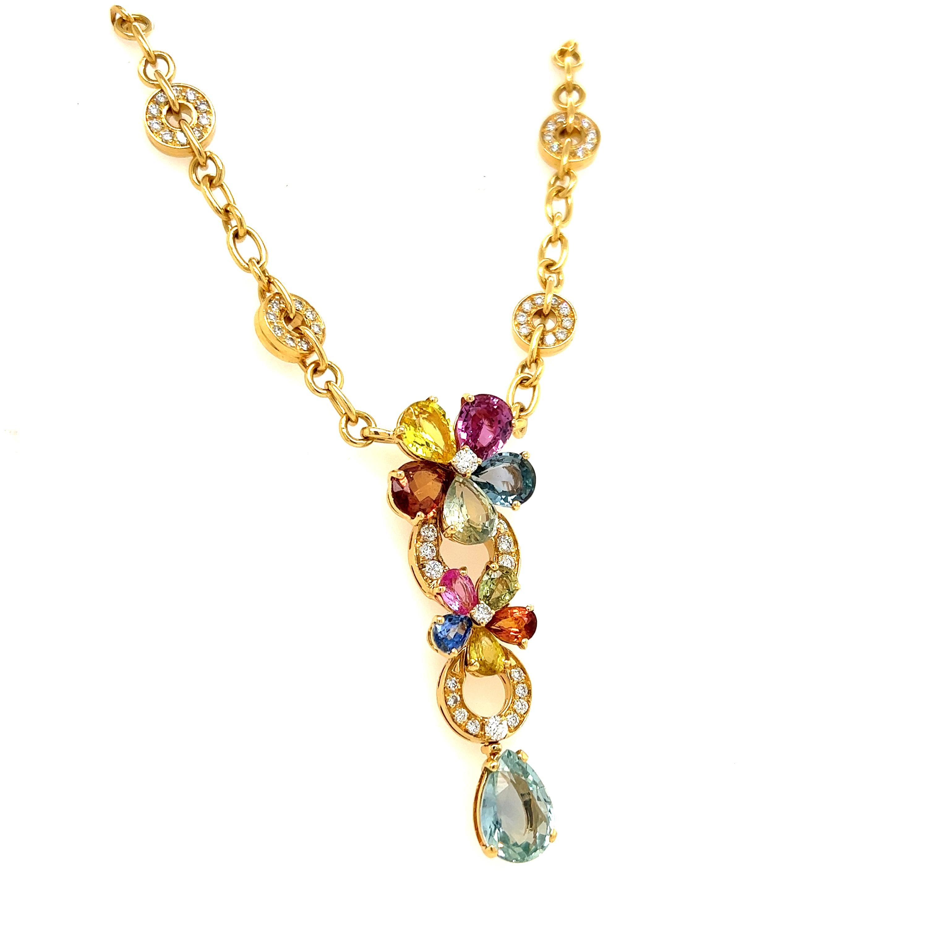 Beautiful creation from famed jewelry house Bvlgari. This elegant necklace is crafted in 18k yellow gold set with natural diamonds and natural sapphires and is a creation from the Sapphire Flower collection by Bvlgari. 
The necklace features two