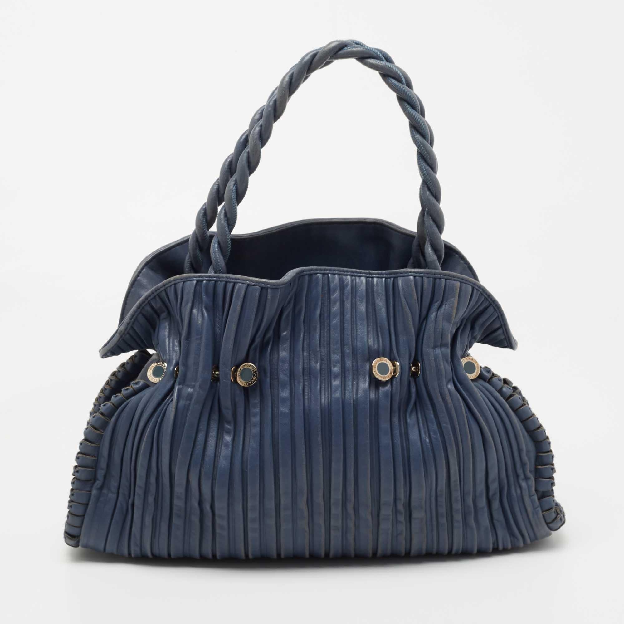 Special days call for special bags, and Bvlgari has just one for you. This gorgeous satchel comes in navy blue and fits more than enough. It is constructed very carefully using pleated leather and thus has a textured feel. Inside the leather