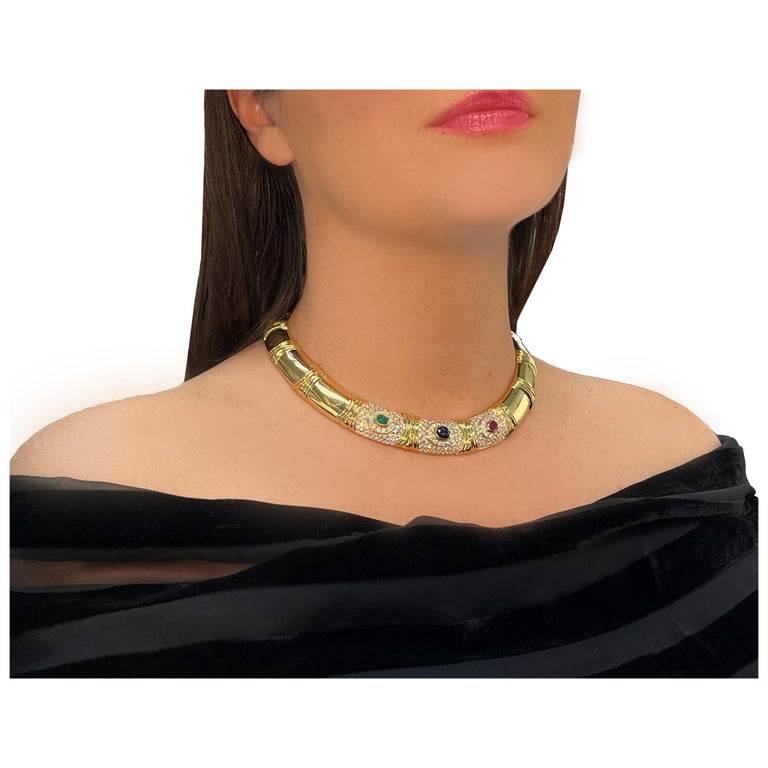 Beautiful Bvlgari necklace/chocker in 18k with approximately 10 carats in VVS clarity E-F color round diamonds features one oval mixed cut ruby, one oval mixed cut emerald and one oval mixed cut sapphire. Necklace signed 