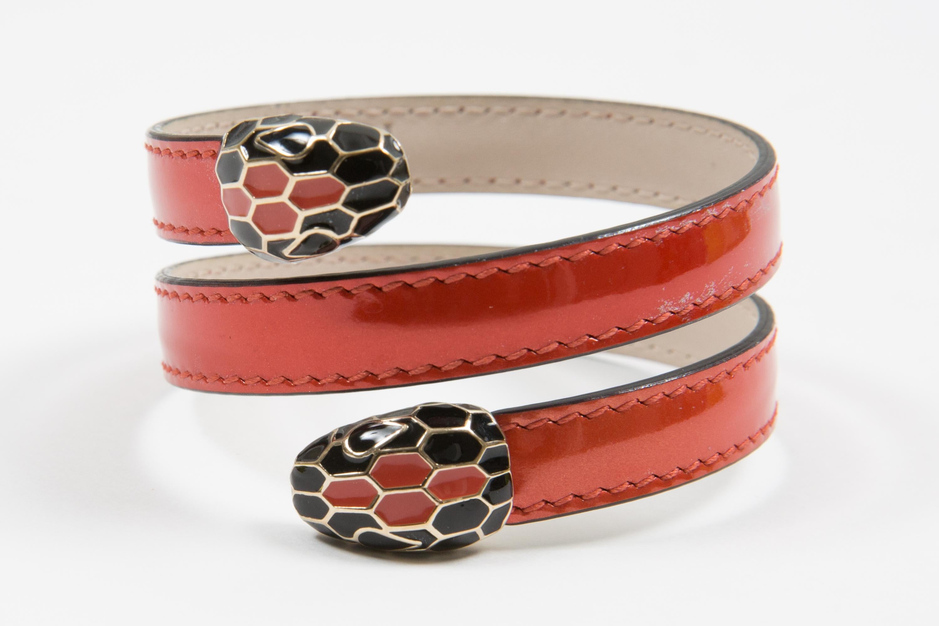 Bvlgari Orange leather snake” Serpenti Forever” two-coil bracelet  featuring an orange calf leather two-coil bracelet, double snakehead décor in light gold-plated brass embellished with black and orange enamel scales, and black enamel eyes.
Circa