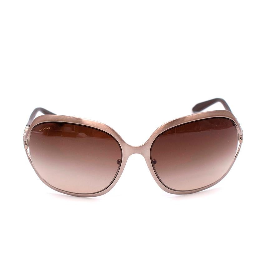  Bvlgari Oversized Brown Embellished Arm Sunglasses
 

 -Silver-tone, embelished crystal detailing on the side 
 -Brown tinted lenses
 -Curved tips
 -Hinged structure
 

 Material 
 Acetate 
 Metal 
 

 Made in Italy 
 

 PLEASE NOTE, THESE ITEMS