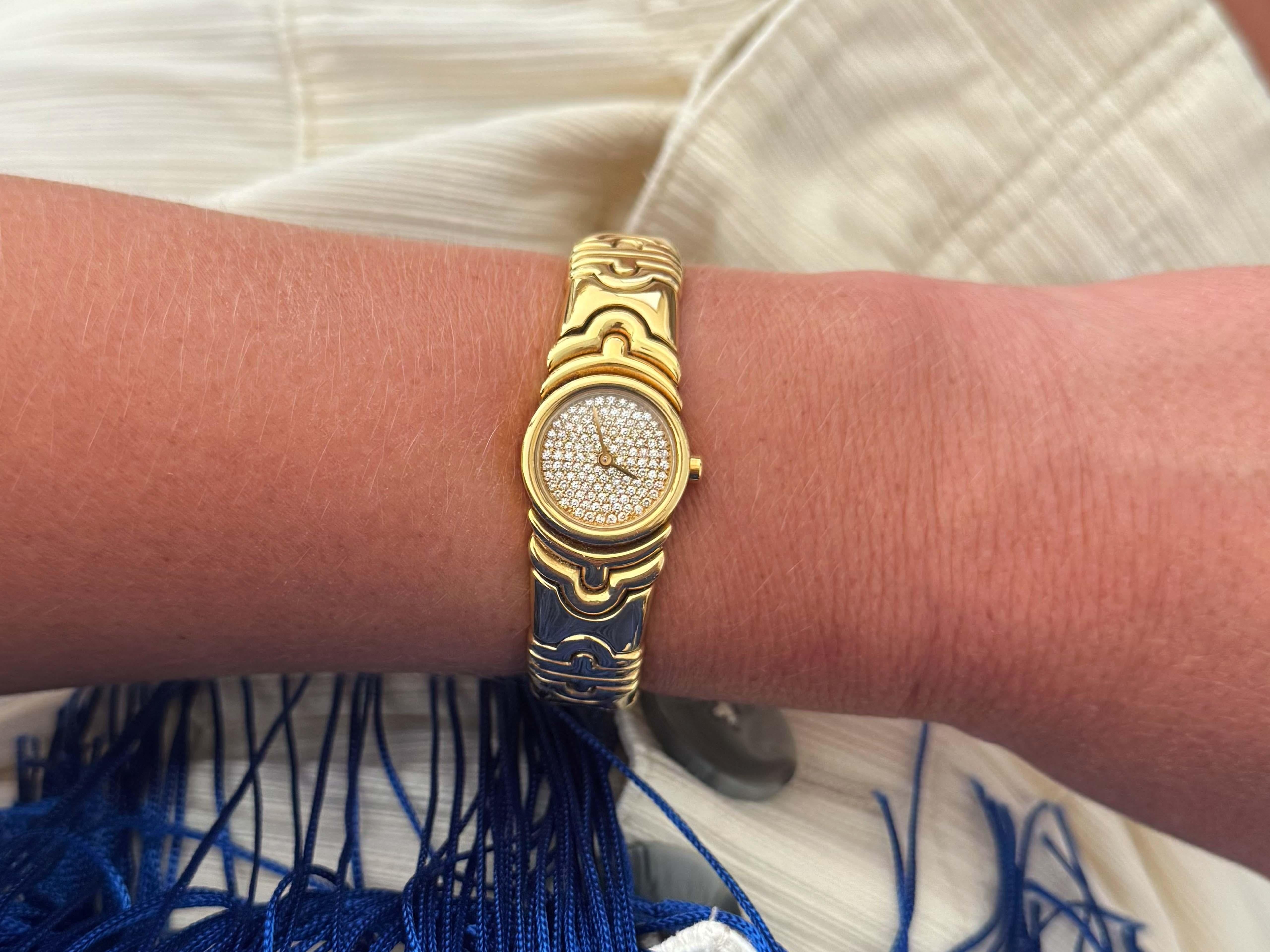 Authentic Bvlgari Parentesi ladies bracelet watch in 18k yellow gold, Ref. BJ 01. This stunning watch features a 20mm 18k gold case with closed solid snap back. The watch has an gold dial Pave' set with diamonds covering the whole face and yellow
