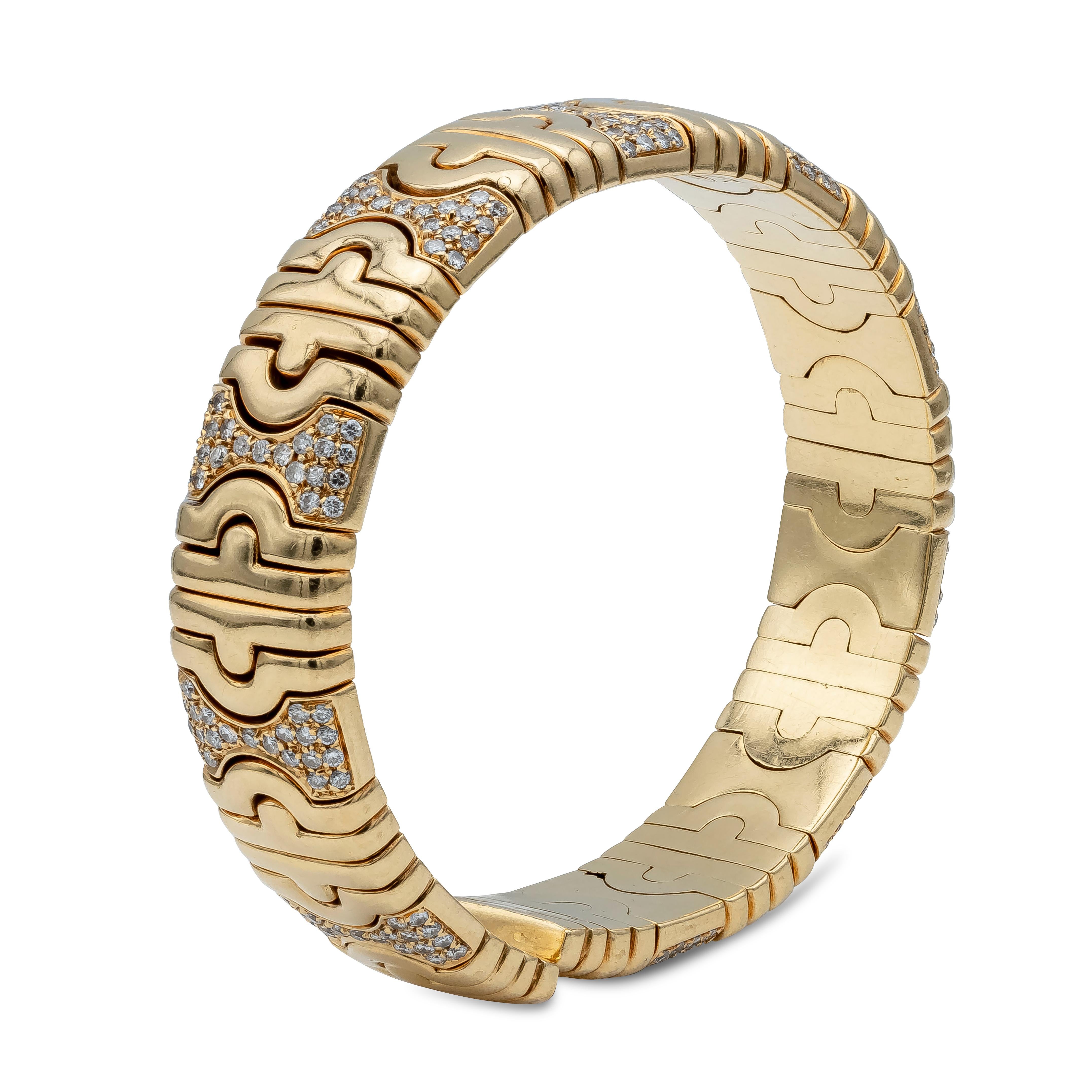 An iconic vintage Bulgari Parentesi 18K Yellow Gold cuff bracelet is composed of sculpted geometric links set with colorless round diamonds for a total weight of 5 carats total, graded F-G Color and VS in Clarity. Has a total gold weight of 80