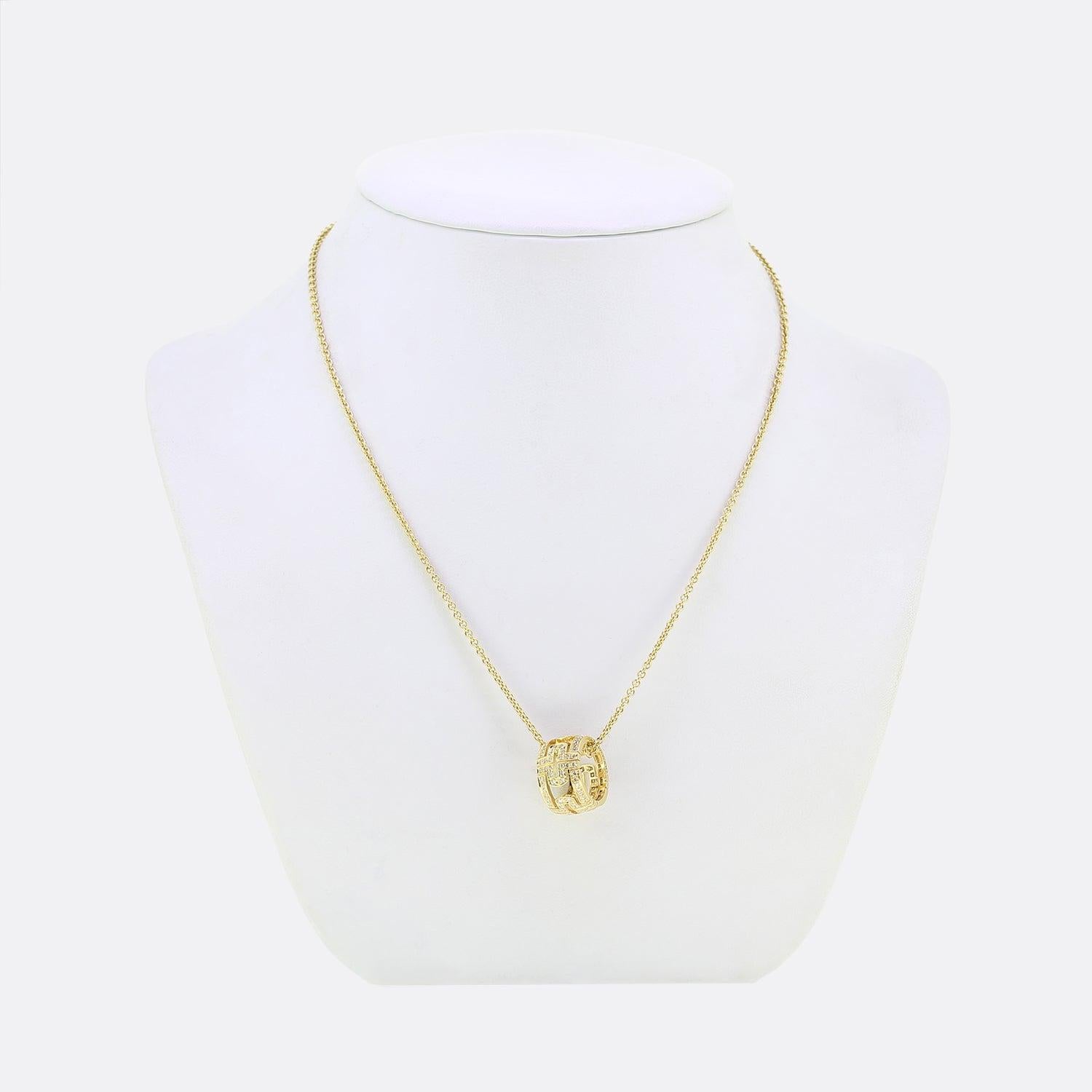 Ecco una collana in oro giallo 18ct della lussuosa casa di gioielli Bvlgari. Questo iconico ciondolo rotondo è stato realizzato con un design aperto su tutta la circonferenza e incastonato con una vasta gamma di piccoli diamanti rotondi taglio