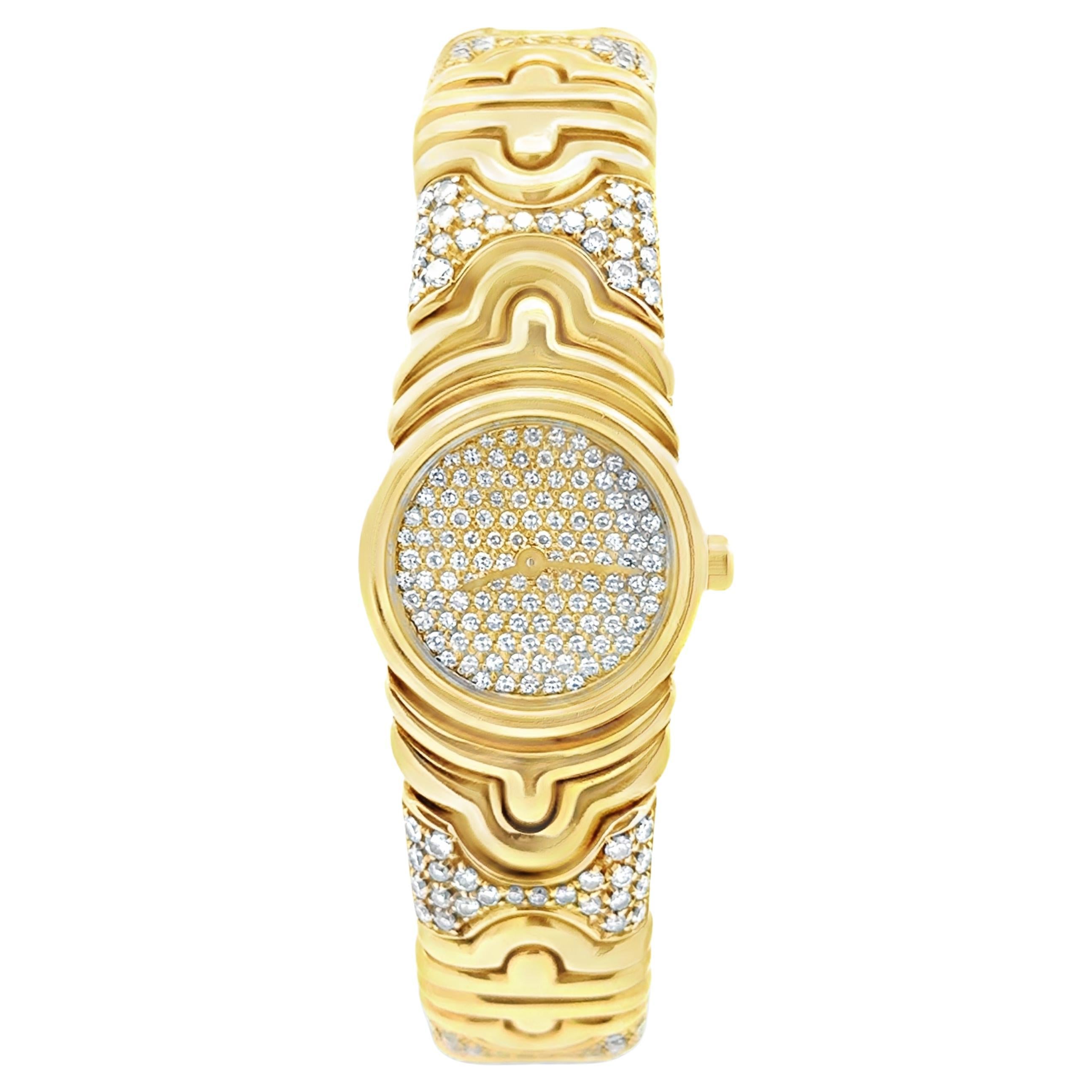 A stylish cuff bangle watch created by Bvlgari from the iconic Parentesi collection, featuring round brilliant cut diamonds, set beautifully on a pavé setting. Finely made with 18K yellow gold. 