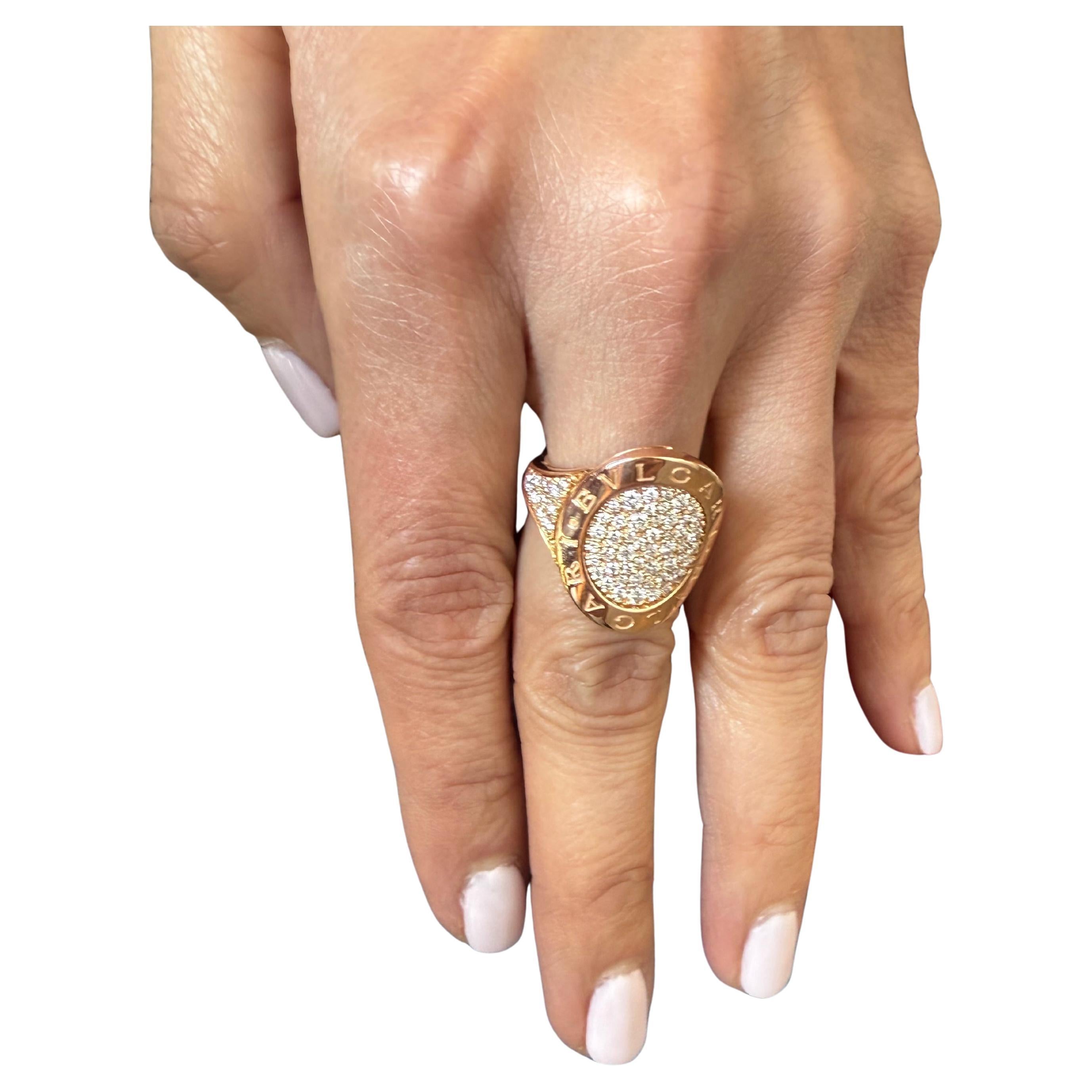 From the Bvlgari Bvlgari Collection, this exquisite piece is crafted from 18K Rose Yellow Gold. It features a 3mm band and the Oval Diamond Pave top of the ring measuring 20mm in length and 17mm in width. 
Hallmarked: Designer Signature, Registered