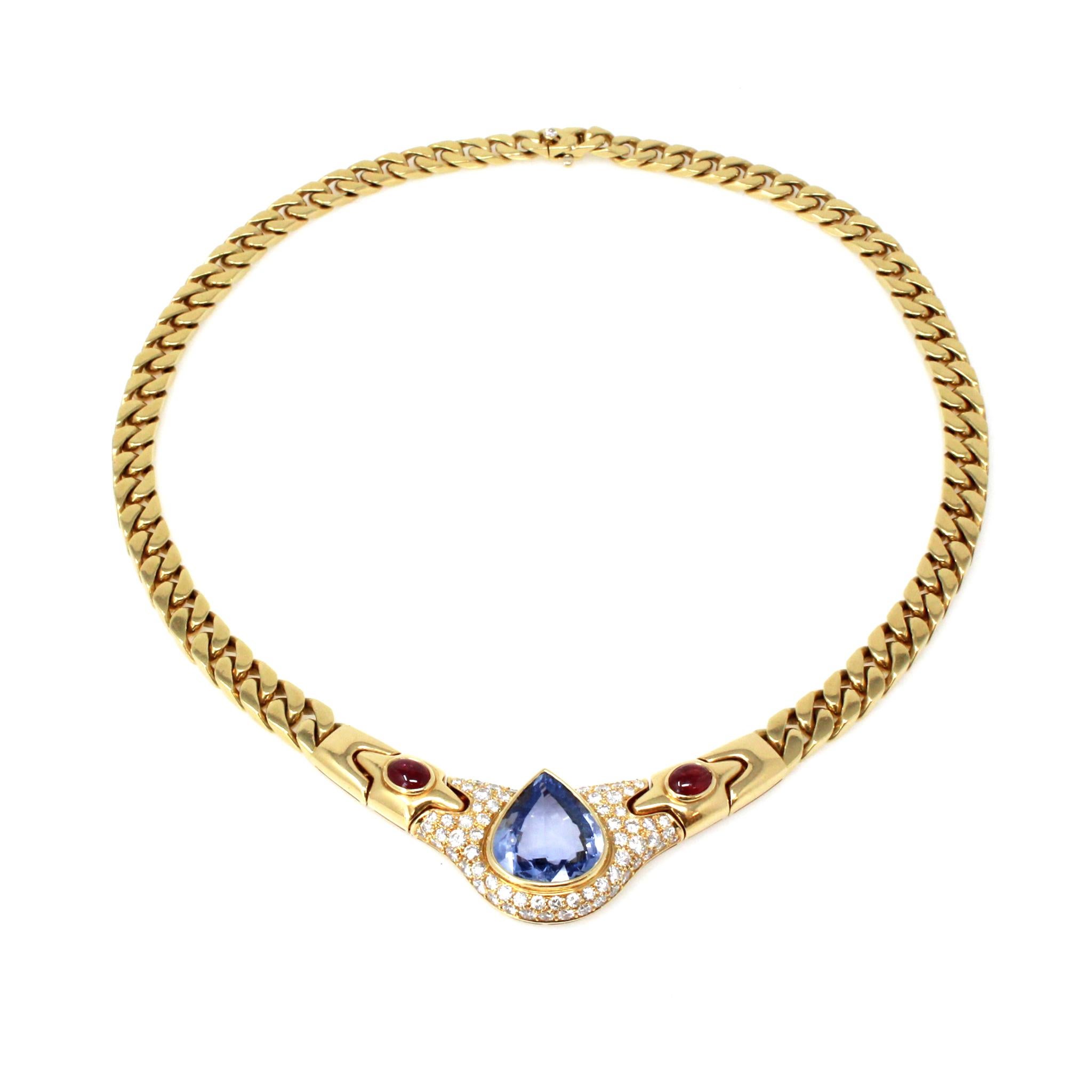 A Signed Bvlgari pear-shaped No Heat Ceylon Sapphire, Ruby and Diamond necklace circa 1980, in 18K yellow gold. Capturing our attention with its mesmerizing no heat pear-shaped 13.36 carat Ceylon Sapphire of VS clarity, this iconic design from