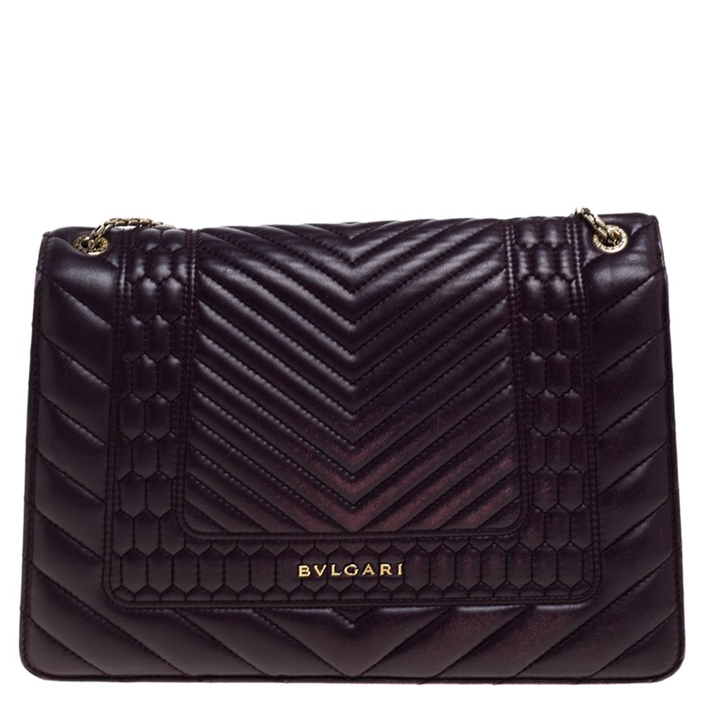 Dazzle the eyes that fall on you when you swing this stunning Bvlgari creation. Crafted from quilted Scagile leather in a breathtaking purple hue, the shoulder bag is styled with a flap that has the iconic Serpenti head closure. The bag has a