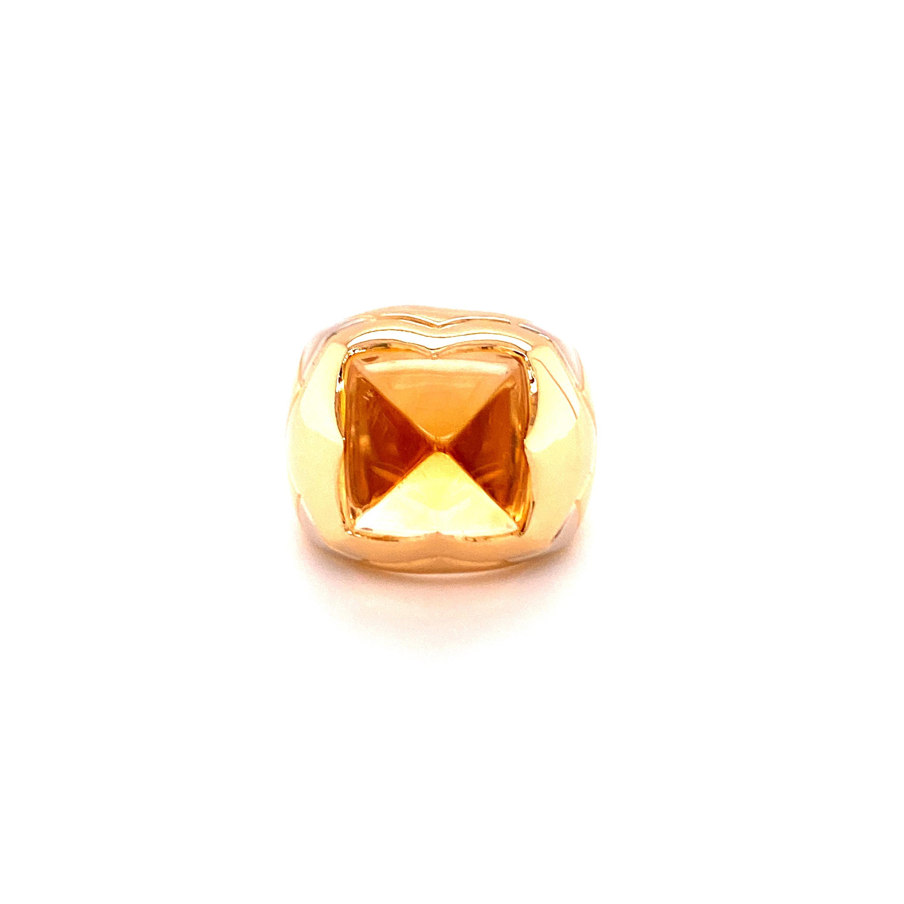 This iconic Bulgari Pyramid ring is made in 18 Karat yellow gold and centrally set with a sugarloaf cabochon Golden Citrine. The shoulders are decorated with white gold elements and engravings. Signed BVLGARI, Made in Italy.

Ring Size: 53.5 / 6.5