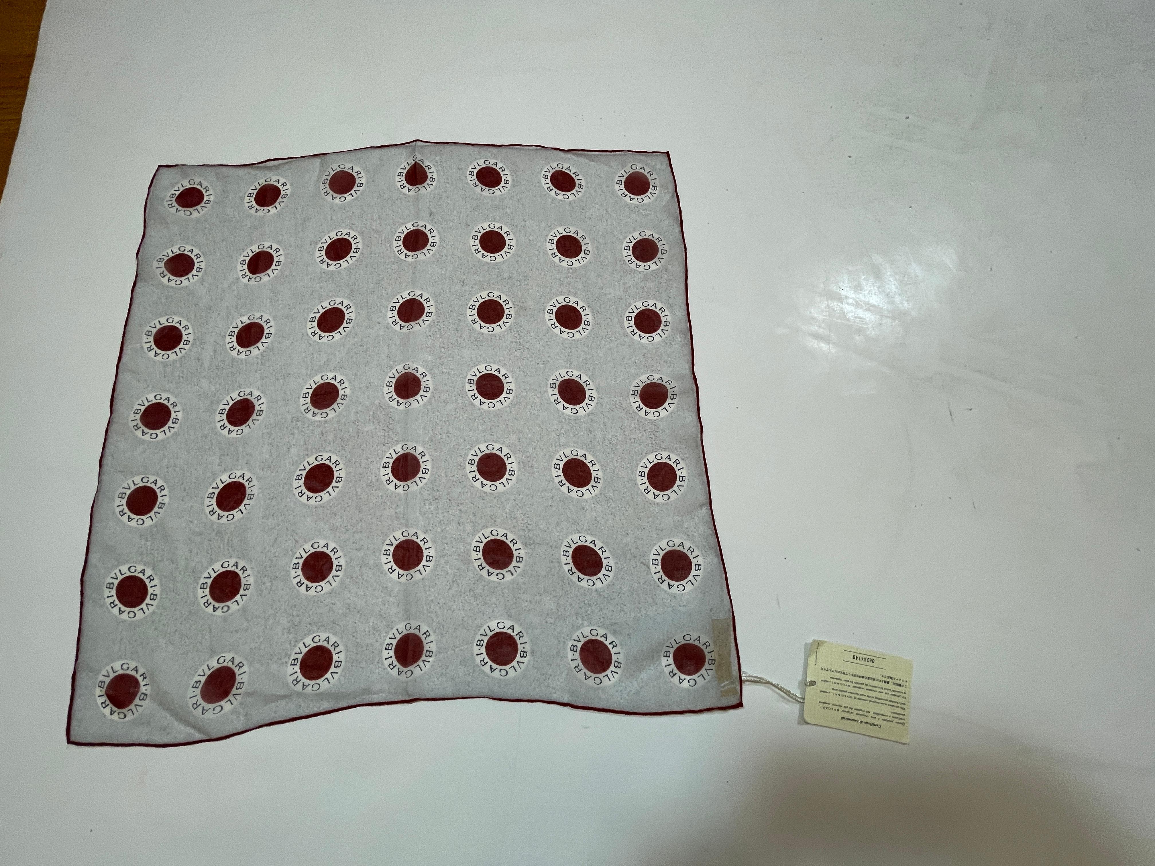 BVLGARI Red Dot Logo Silk Scarf, new with tag.
Square Bvlgari georgette silk scarf red dot logo printed motif, hand-sewn rolled edges. 
This scarf is in pristine condition new with original tag and certificate of authenticity.
Designer:
