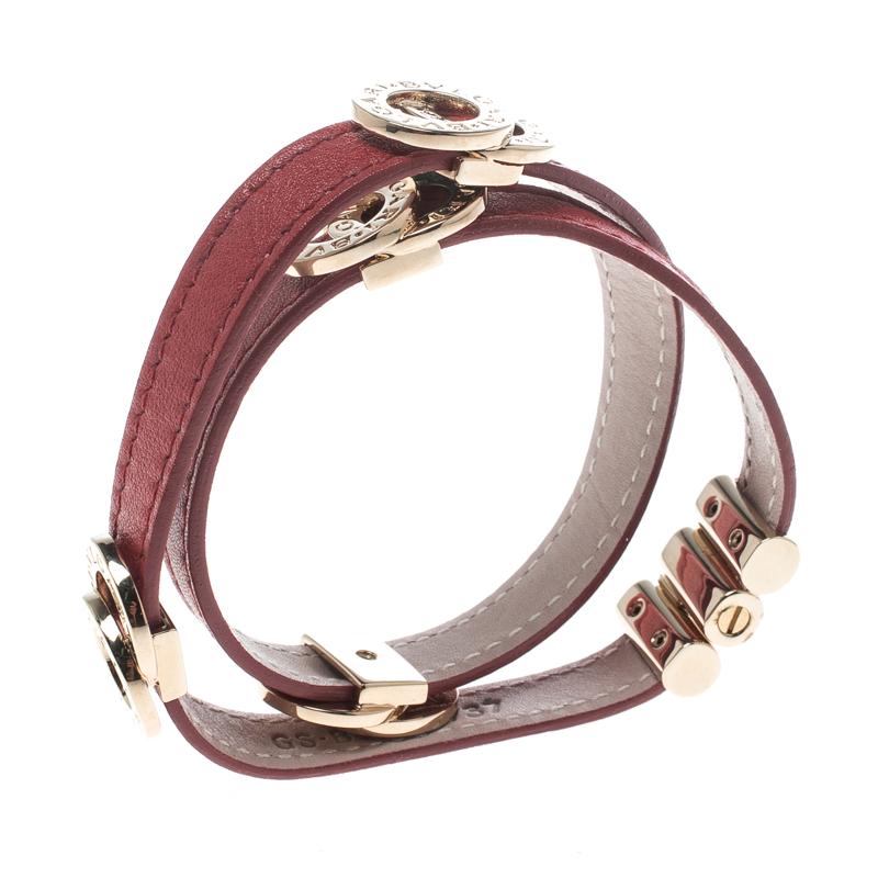 This bracelet from Bvlgari exudes style and chicness. Subtly designed in a coiled wrap style with red leather, the bracelet is accented by gold-tone interlocking rings, engraved with the brand's name. A push clasp completes this lovely
