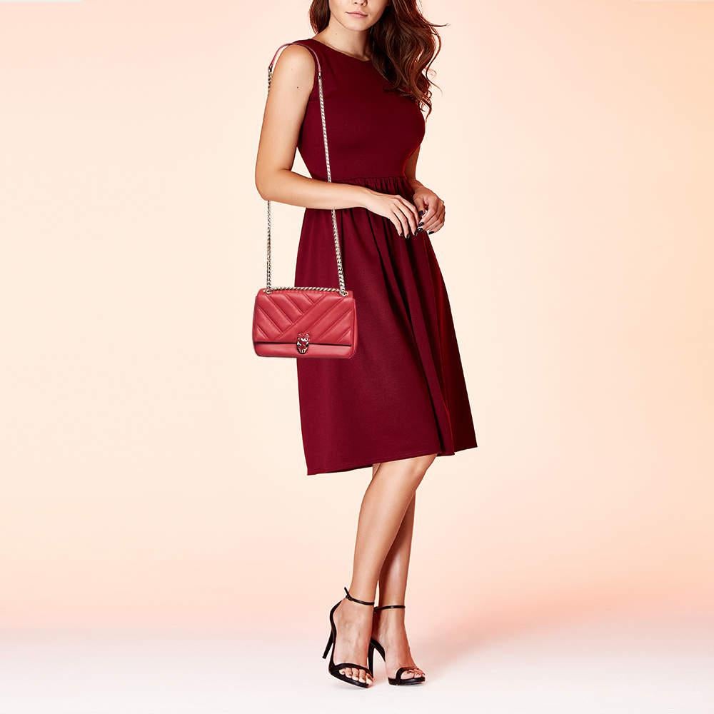 Crafted in vibrant red quilted leather, the Bvlgari Serpenti Shoulder Bag exudes timeless charm. Its sleek design is accentuated by the iconic snakehead closure embellished with captivating eyes. Perfect for the modern woman, it seamlessly blends