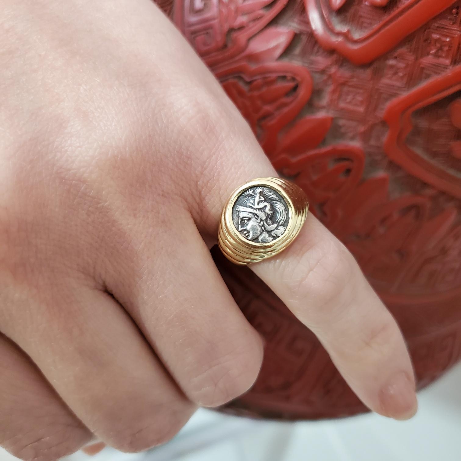 Signet ring with an ancient Greek coin designed by Bvlgari.

Very handsome Moneta signet ring created in Roma Italy by the jewelry house of Bvlgari back in the late 1970's. This ring has been crafted with stepped patterns in solid yellow gold of 18