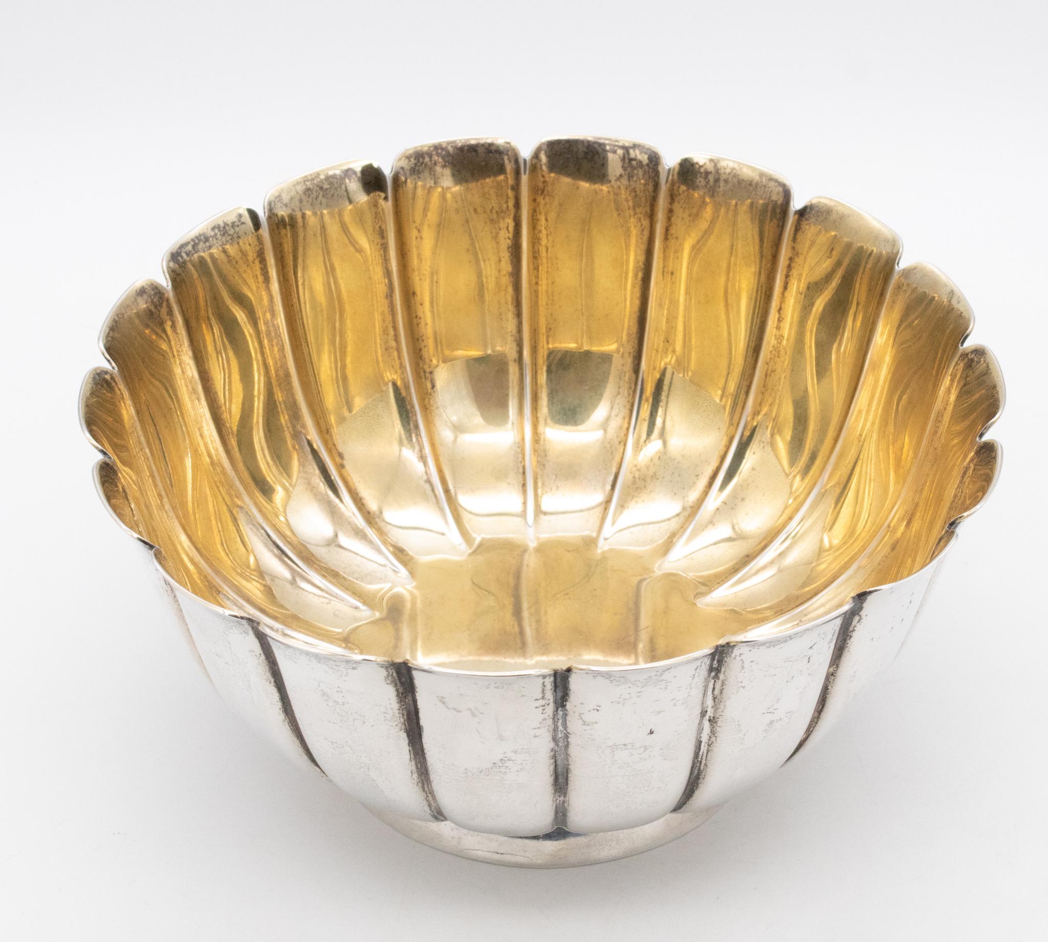 Scalloped bowl dish designed by Bvlgari.

Beautiful vintage fluted piece made in Rome, Italy by the luxury house of Bulgari. This large scalloped dish has been carefully crafted in solid .925/.999 sterling silver with 24 kt gold gilding in the