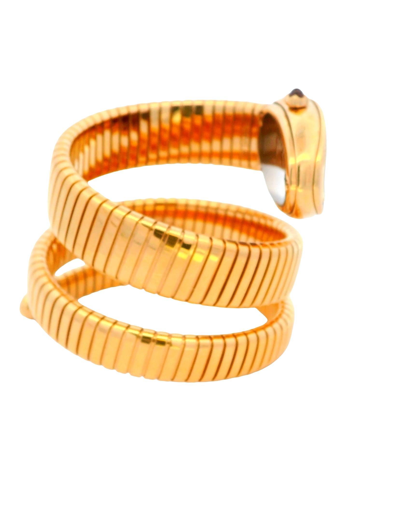 Bvlgari Serpenti Tubogas watch in 18k rose gold featuring a curved case set with an original diamond bezel. The watch includes a cabochon pink rubelite crown and a black guilloche opaline dial, complemented by a double spiral bracelet. It operates
