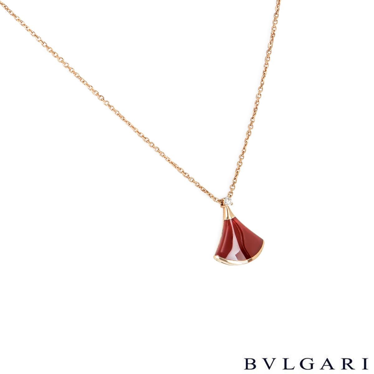 An elegant 18k rose gold carnelian and diamond jewellery suite by Bvlgari from the Divas' Dream collection. The pendant features a carnelian fan shaped motif with a single round brilliant cut diamond set above weighing 0.03ct, is suspended from a
