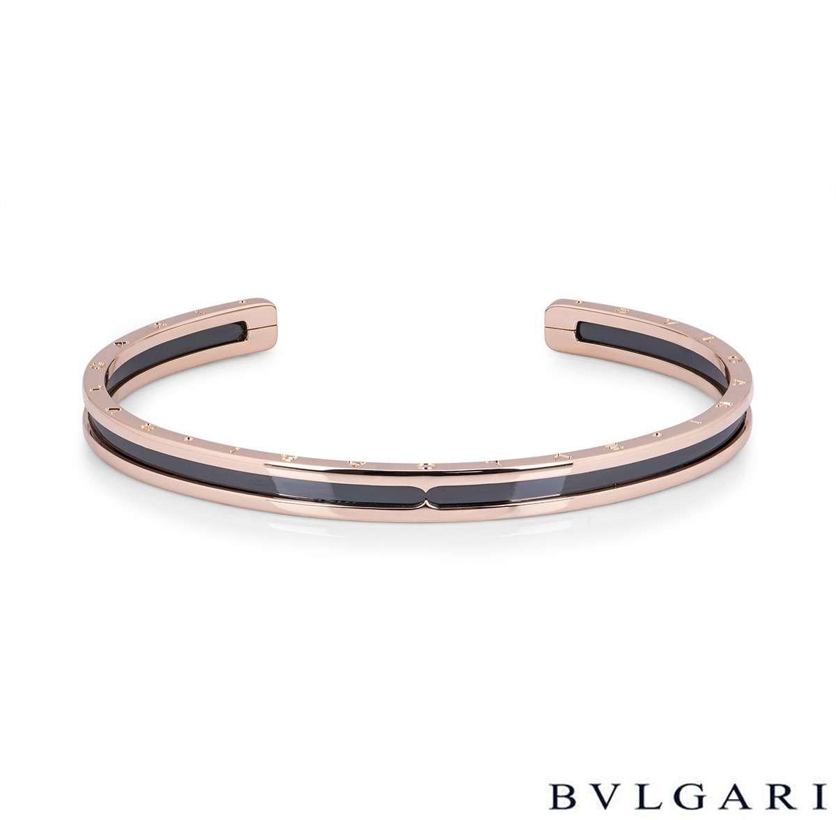 An 18k rose gold cuff bracelet by Bvlgari from the B.zero1 collection. The outer edge of the bracelet has 'Bvlgari Bvlgari' engraved on both sides and features a black ceramic middle section. The bracelet is a cuff design in size large and would fit
