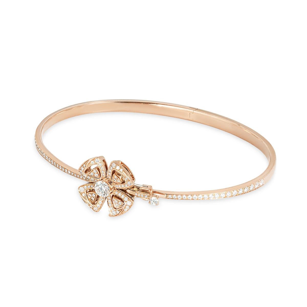 An alluring 18k rose gold diamond bracelet by Bvlgari from the Fiorever collection. The bracelet coils around the wrist and finishes with a flower motif, set to the center with a single round brilliant cut diamond with an approximate weight of
